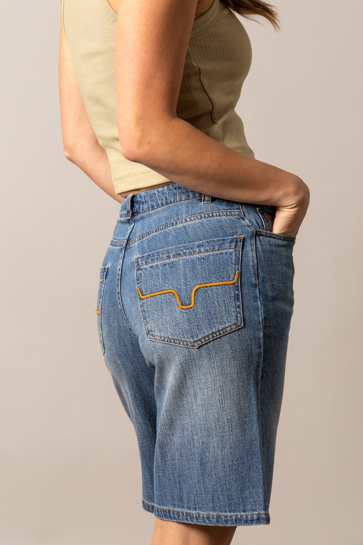 Kimes Ranch Staci jeans in Antique Wash, side view, with signature orange stitching on the back pocket