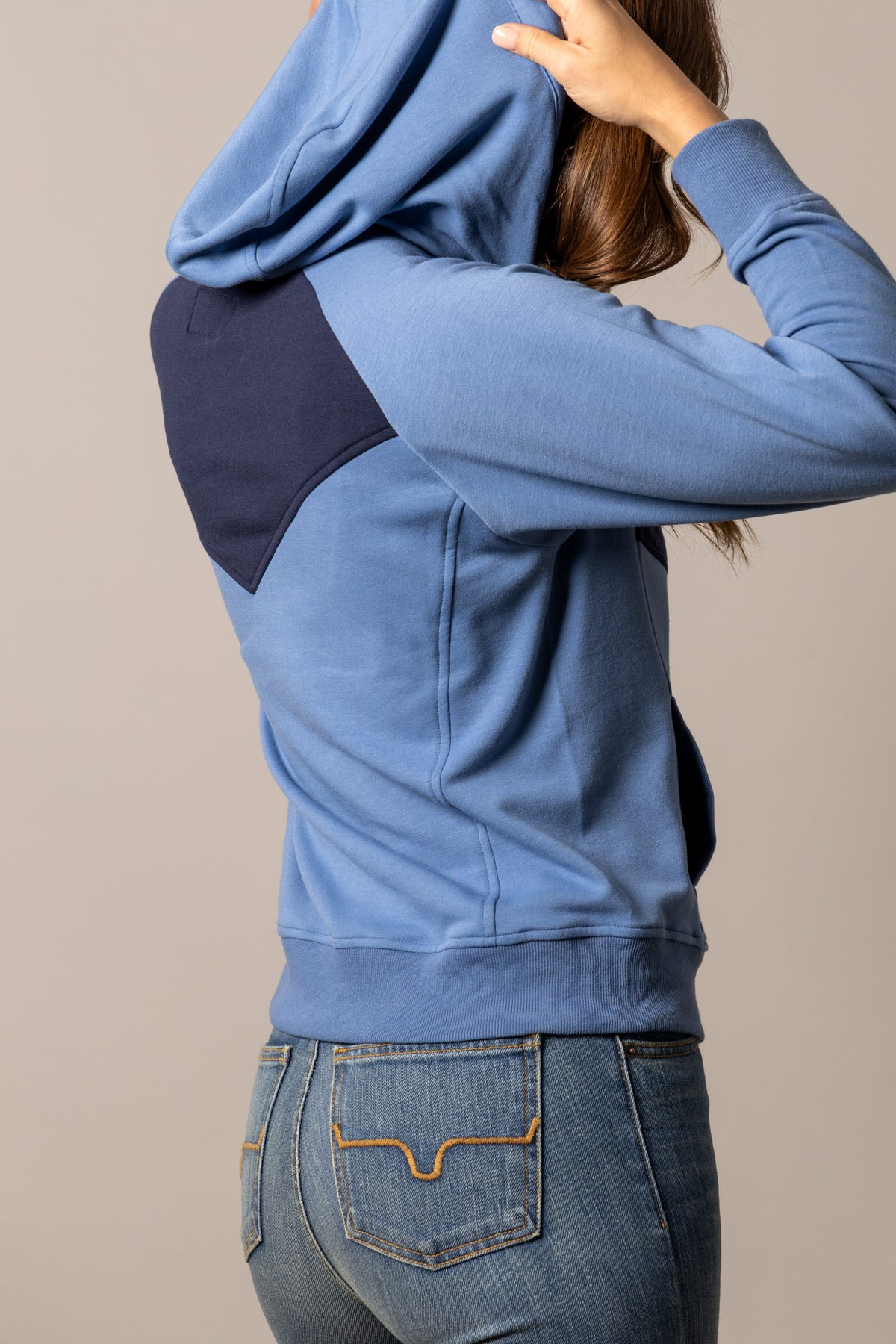 Kimes Ranch Stella hoodie in Mid Blue, side view, with navy shoulder panel and ribbed cuffs