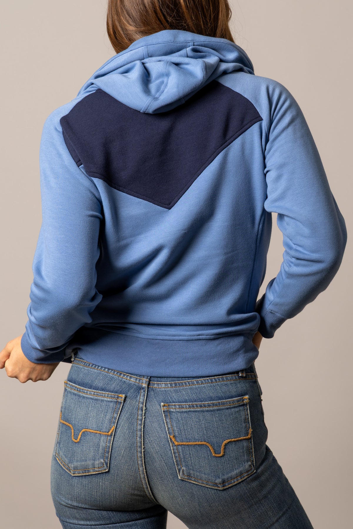 Kimes Ranch Stella hoodie in Mid Blue, back view, with a navy back yoke panel and long sleeves