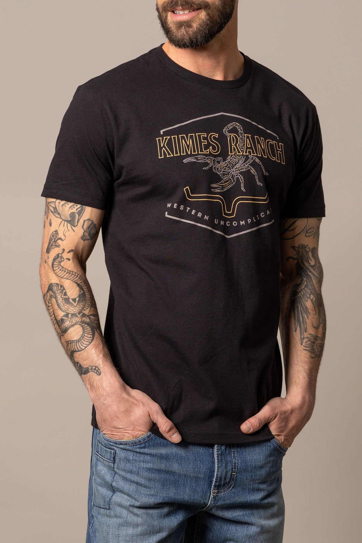 Kimes Ranch Sting shirt in Black with a graphic of a scorpion and the text Western Uncomplicated