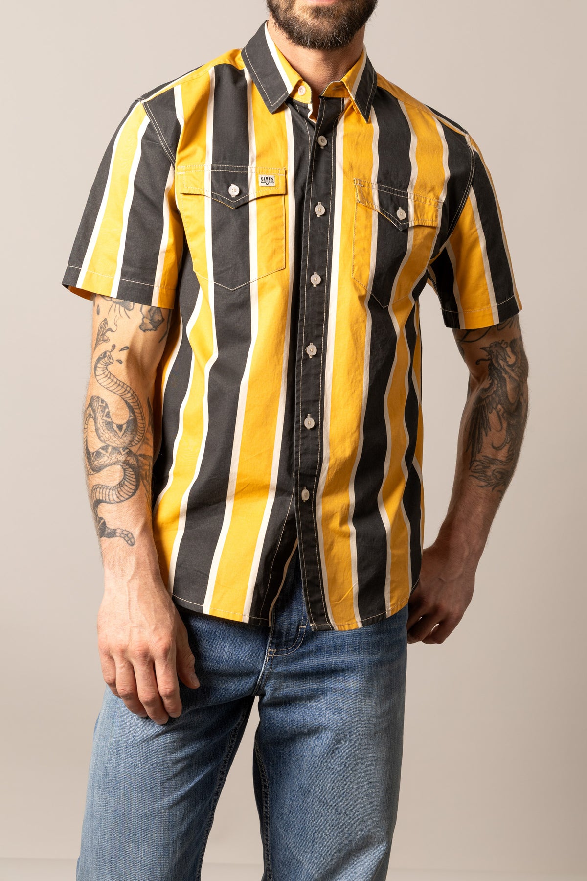 Kimes Ranch Stoppy dress shirt in Black with yellow and white vertical stripes, short sleeves, and two chest pockets