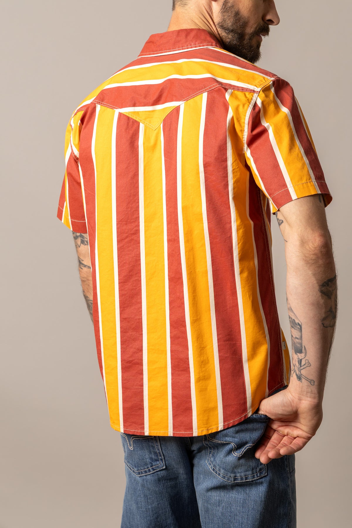 Kimes Ranch Stoppy, back view, dress shirt with vertical Brick Red and yellow stripes and white piping