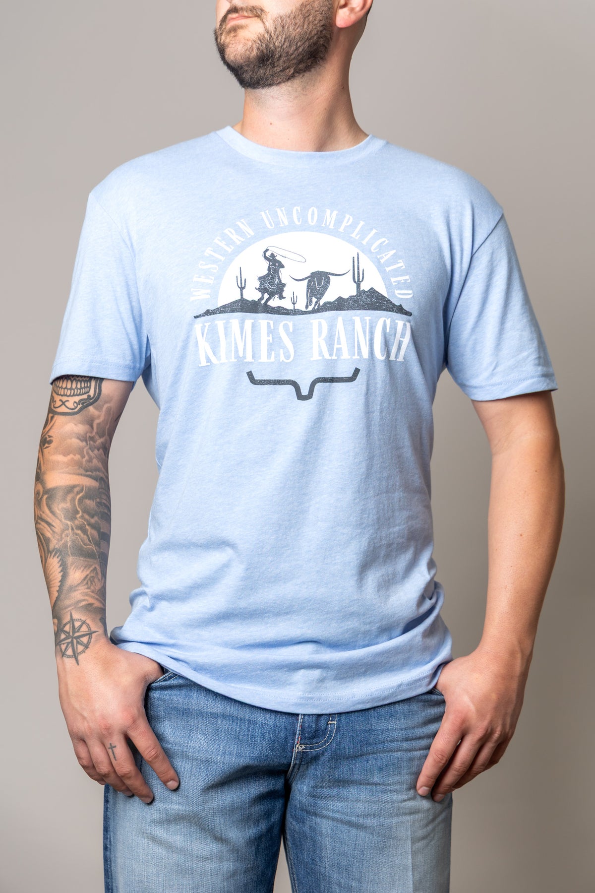 Kimes Ranch The Chase shirt in Heather Columbia Blue with a Western Uncomplicated graphic and Kimes Ranch logo