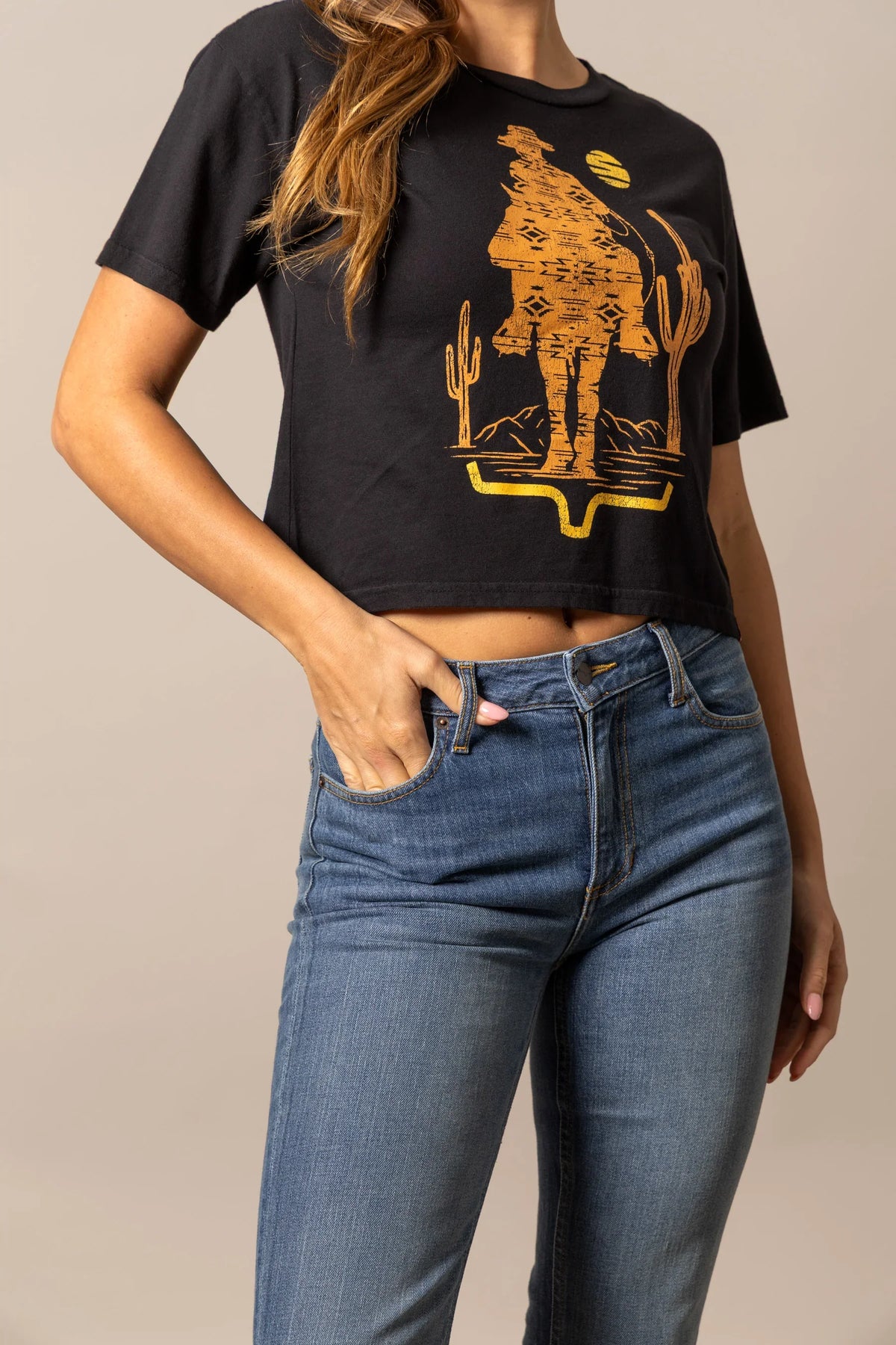 Kimes Ranch The Road Black short sleeve shirt with a gold graphic of a cowboy and cactus
