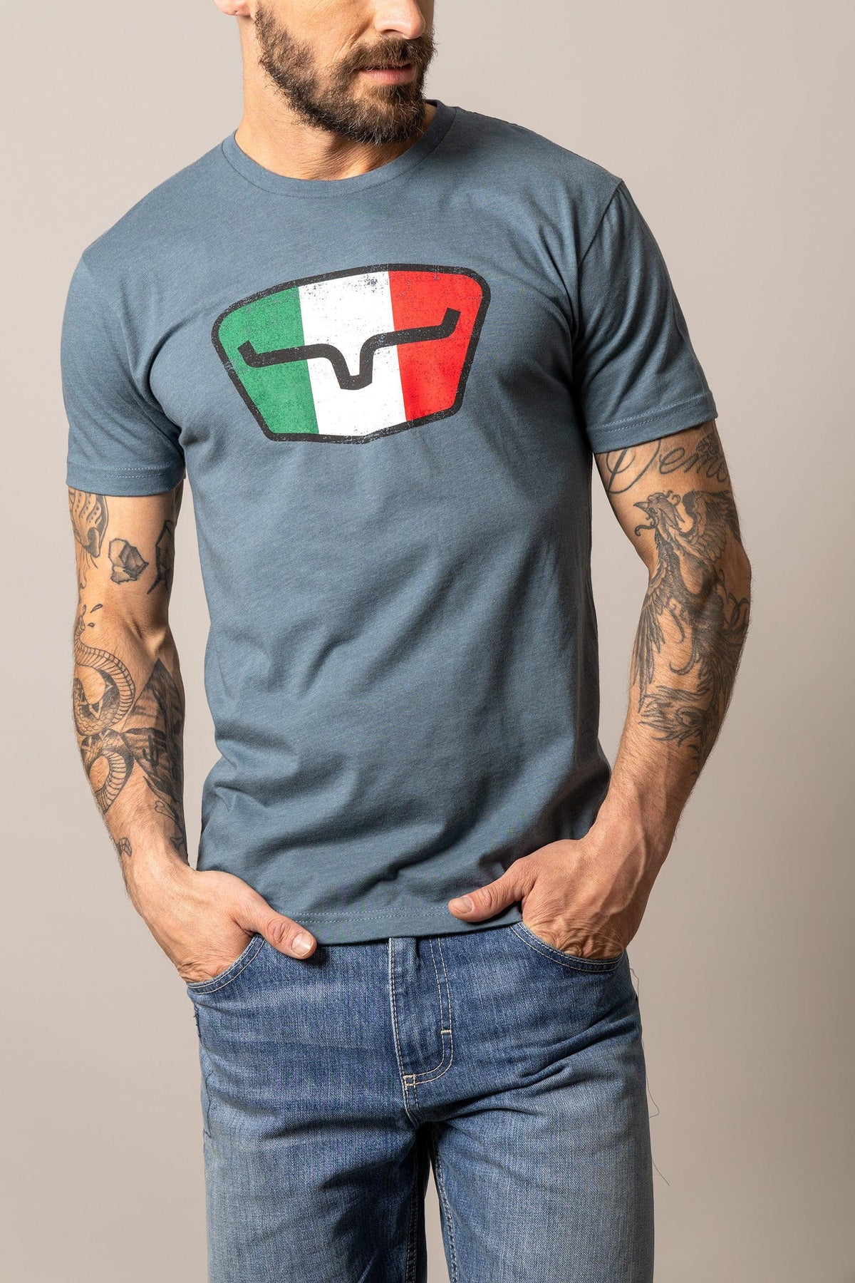 Kimes Ranch Tri-Color Tee in Indigo with a distressed shield graphic featuring green, white, and red vertical stripes