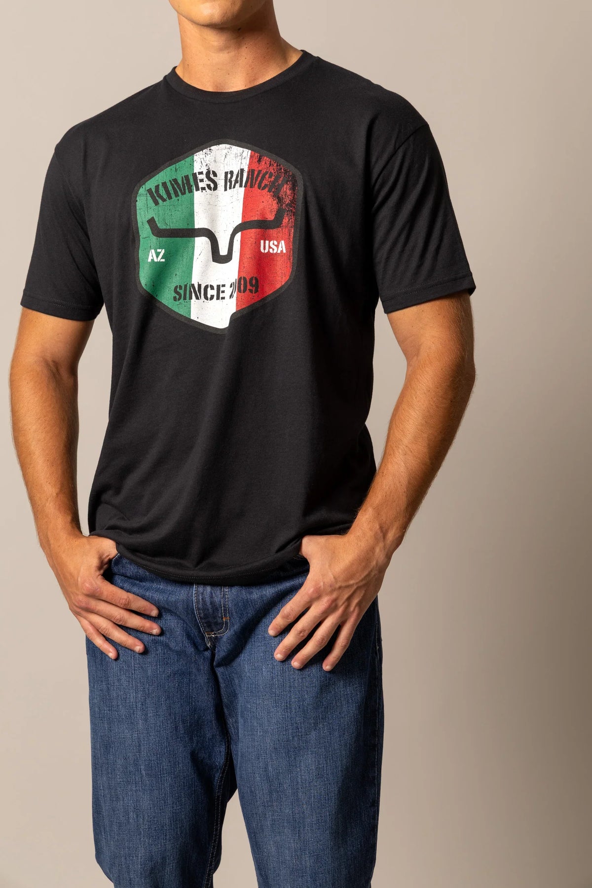 Kimes Ranch Triple Stripe shirt in Black with a shield graphic featuring the Kimes Ranch logo and text AZ USA SINCE 2009
