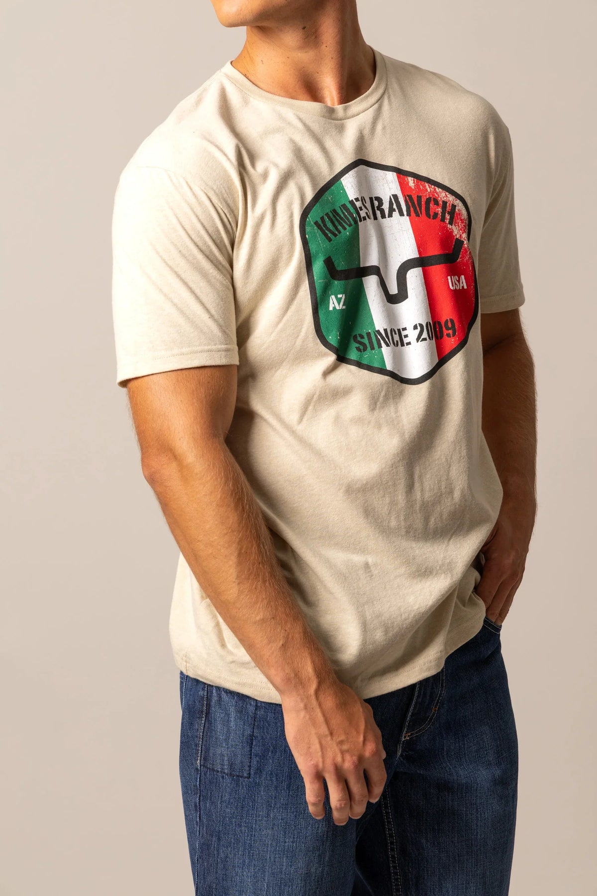 Kimes Ranch Triple Stripe shirt in Natural with shield graphic featuring green, white