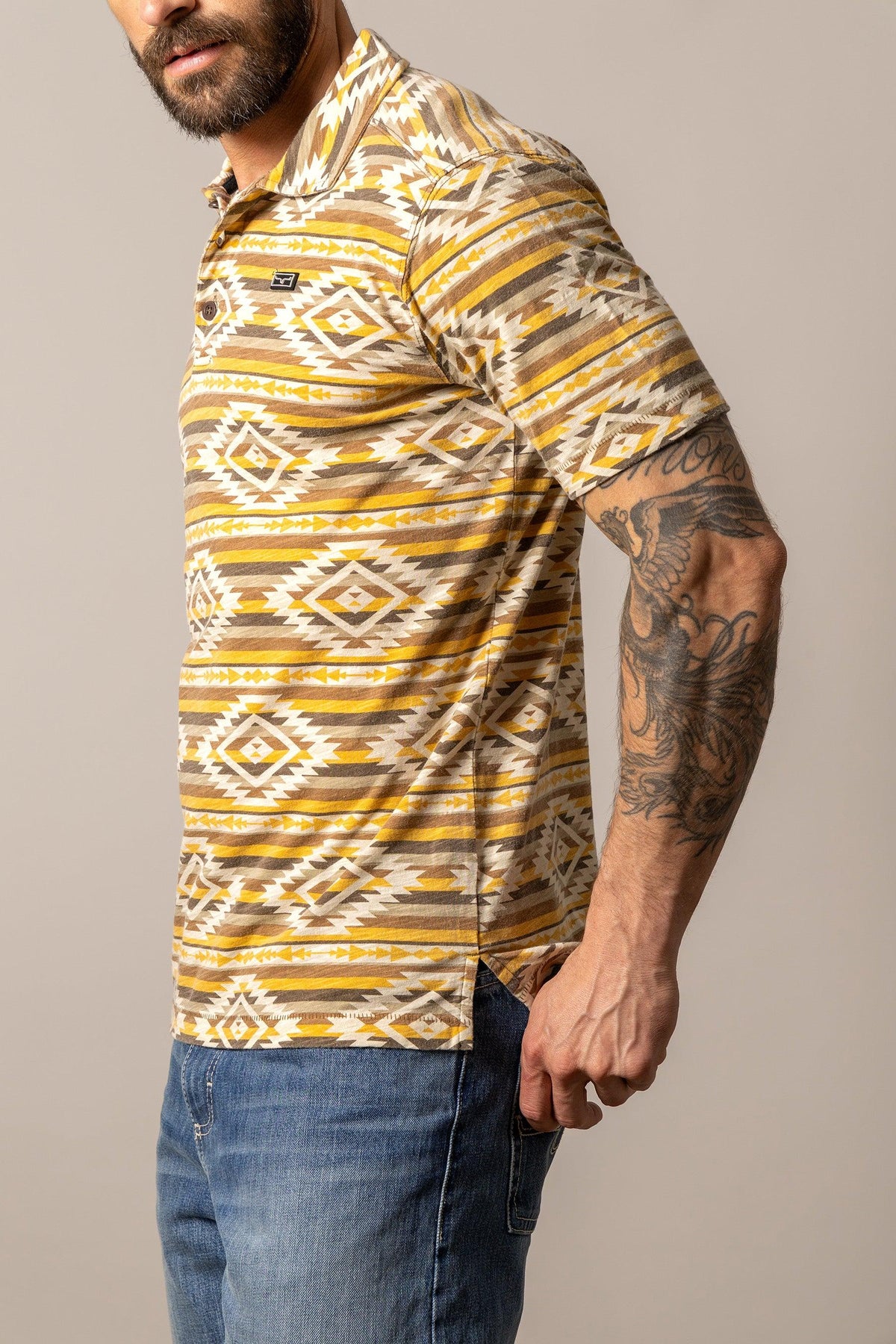 Kimes Ranch Tulum Polo in Gold, side view, with a geometric pattern and short sleeves