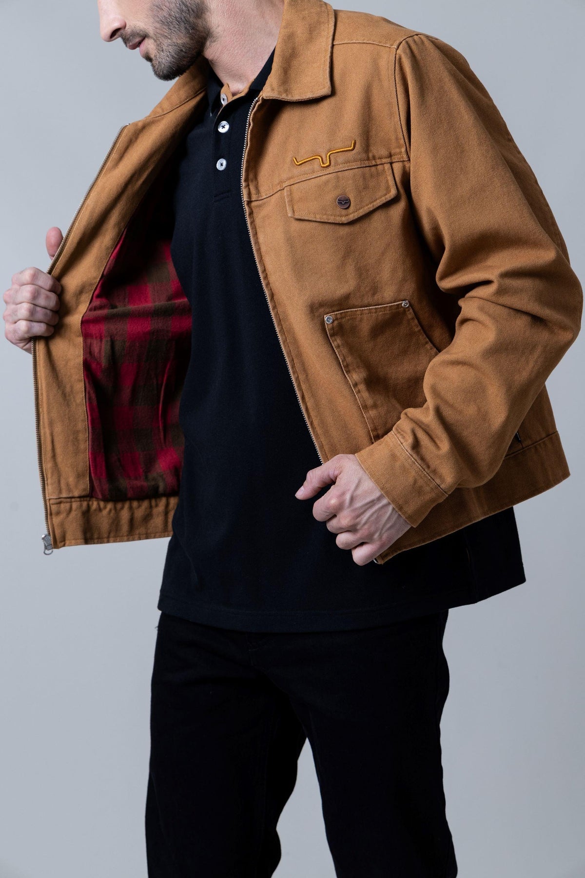 Kimes Ranch Logan Jacket in Work Wear Brown, side view, with red plaid lining and embroidered logo