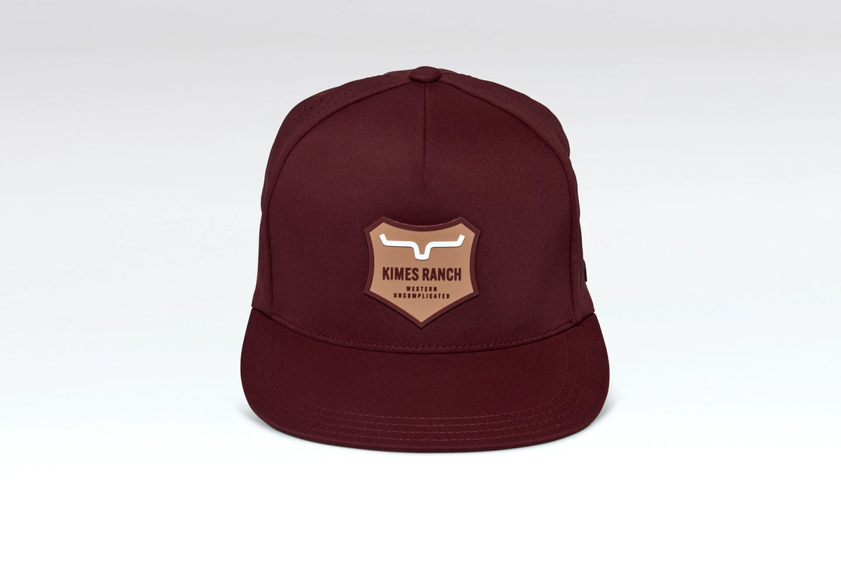 Kimes Ranch Vista hat in Burgundy with a shield logo patch on the front
