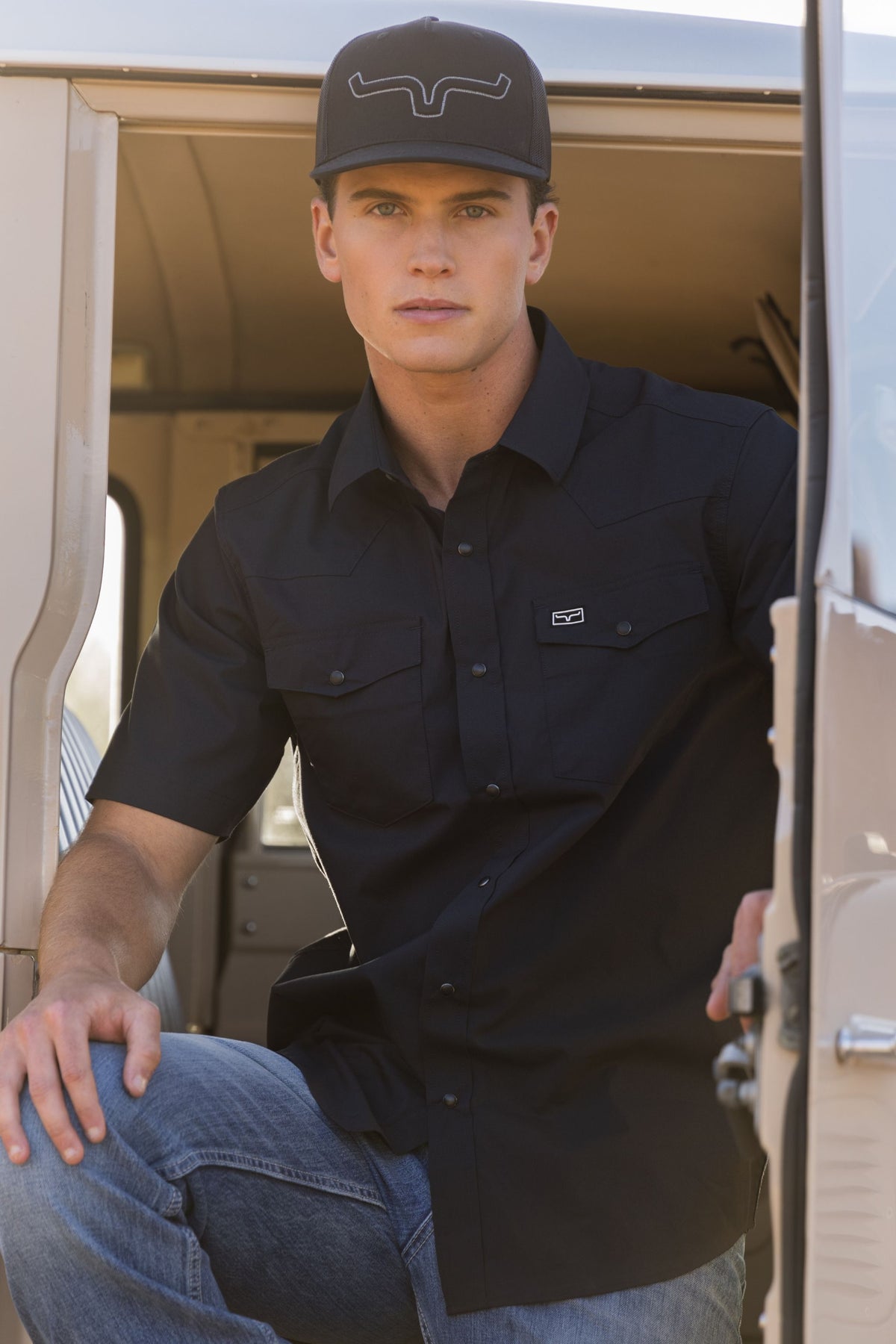 Kimes Ranch Rio Short Sleeve Dress Shirt in Black with chest pockets and a logo on the left pocket