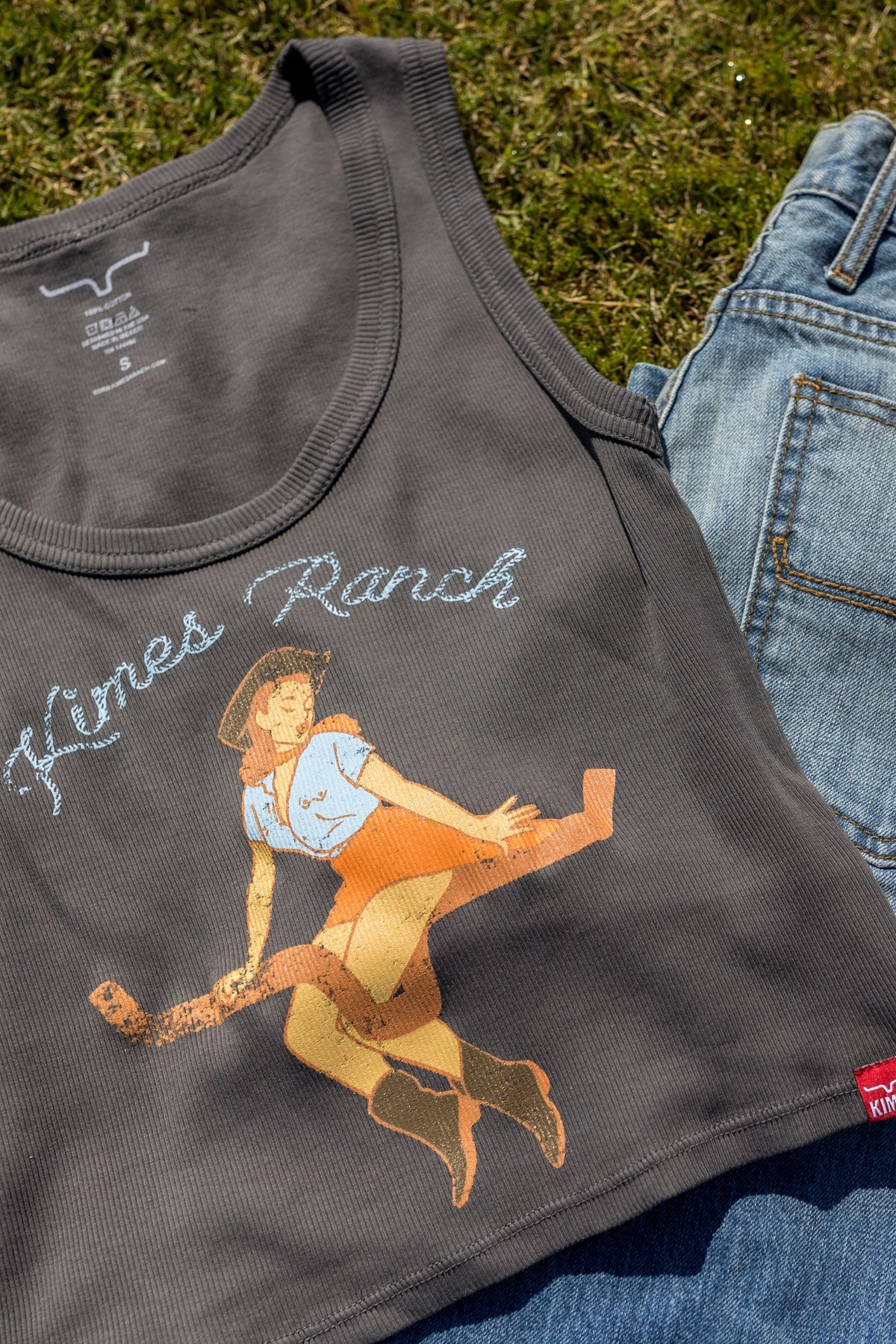 Kimes Ranch See Saw shirt in Black, close-up, with a vintage graphic of a girl on a seesaw and Kimes Ranch text