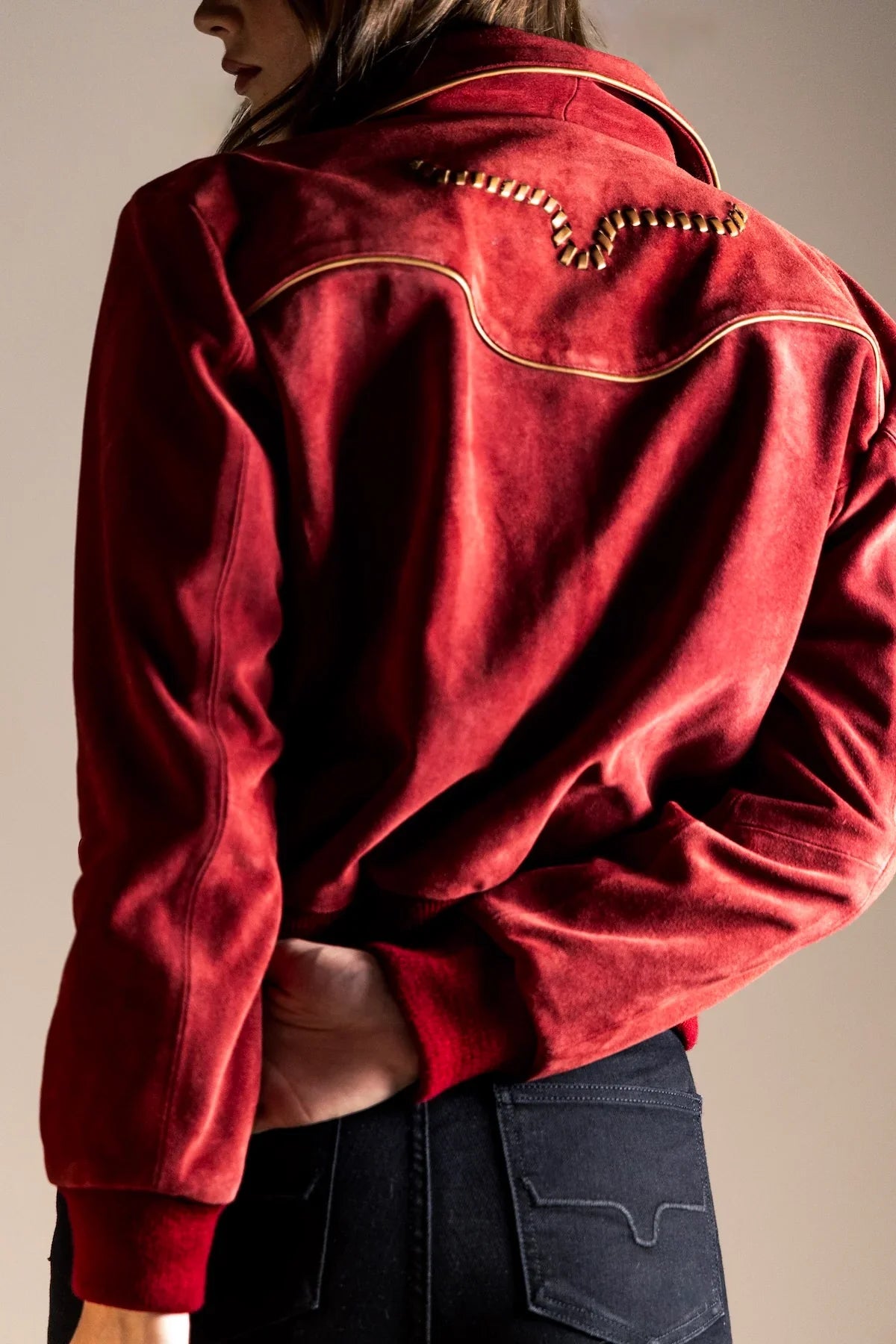 Kimes Ranch KR x Western & Co. Bomber Jacket, back view, in red with gold piping and logo on the back yoke
