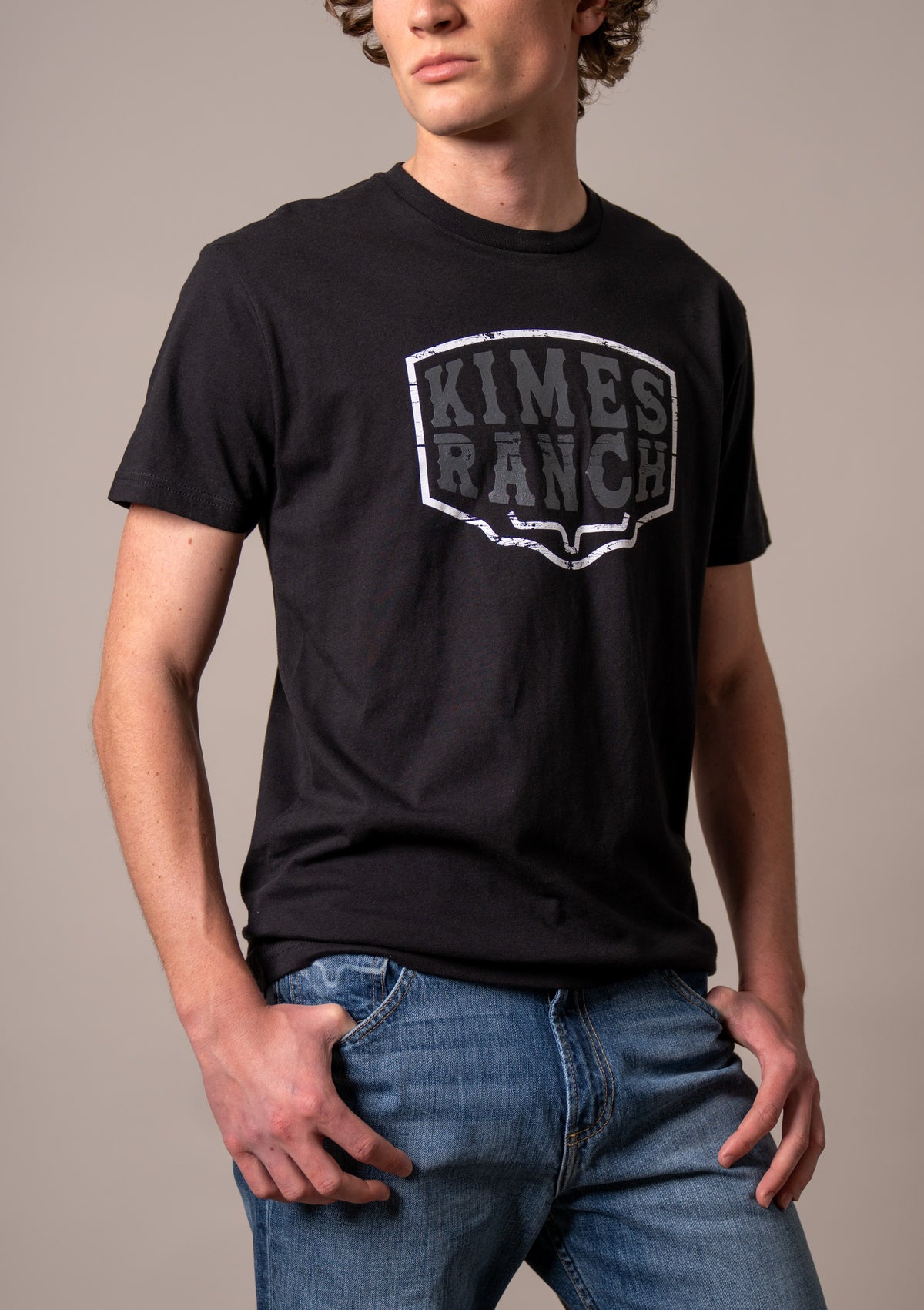 Kimes Ranch Wood Block shirt in Black with a distressed shield logo graphic on the front