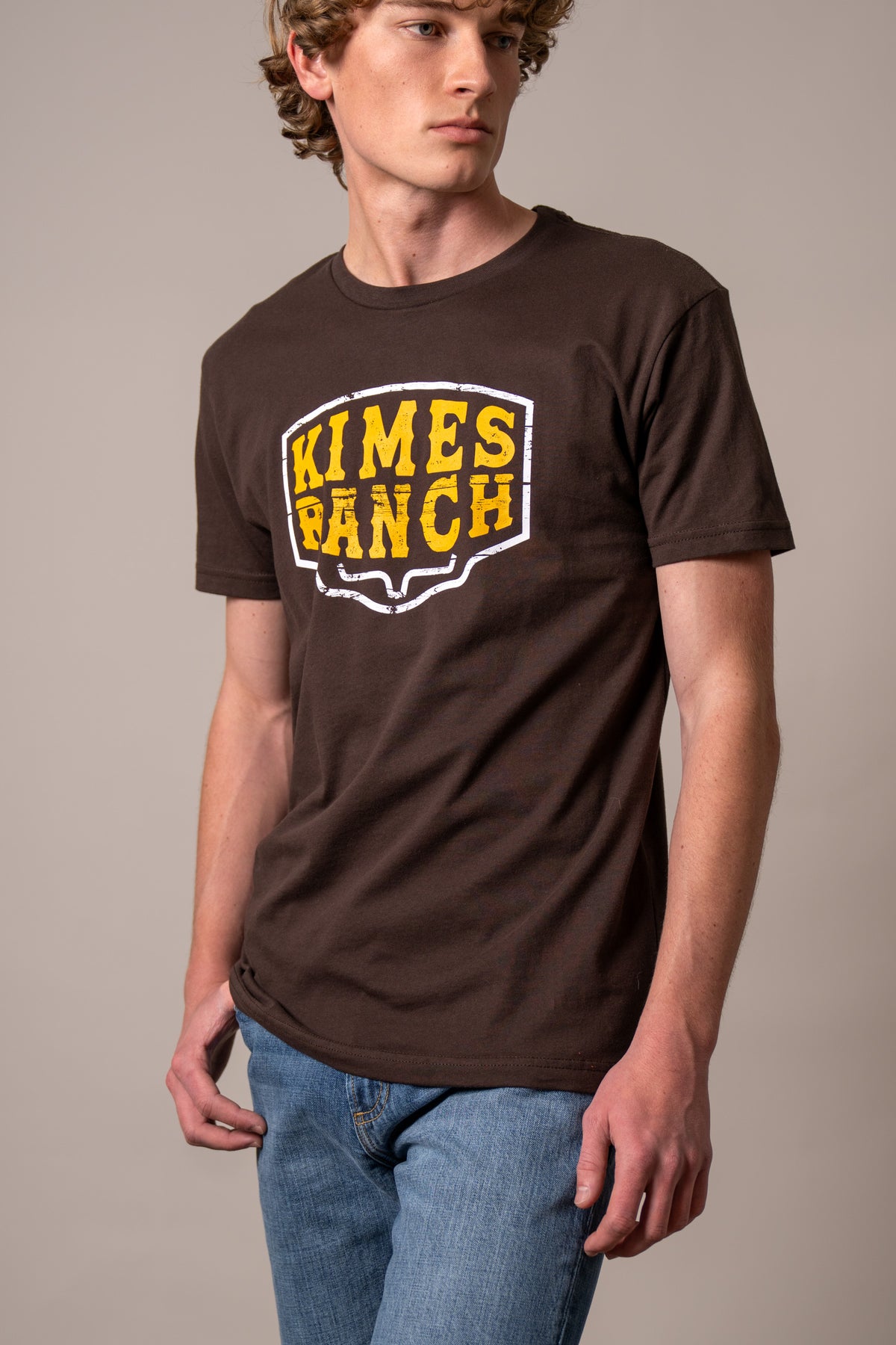 Kimes Ranch Wood Block shirt in Dark Chocolate with a yellow and white Kimes Ranch logo graphic