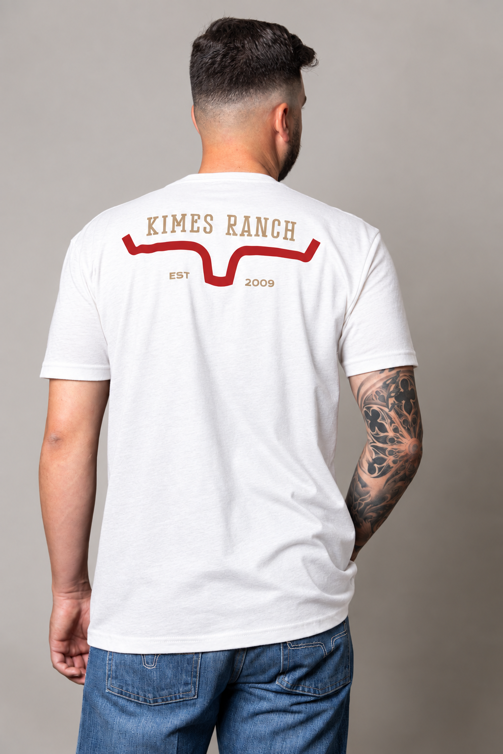 Kimes Ranch Bar Doors, back view, White shirt with a back graphic featuring the Kimes Ranch logo and EST 2009 text