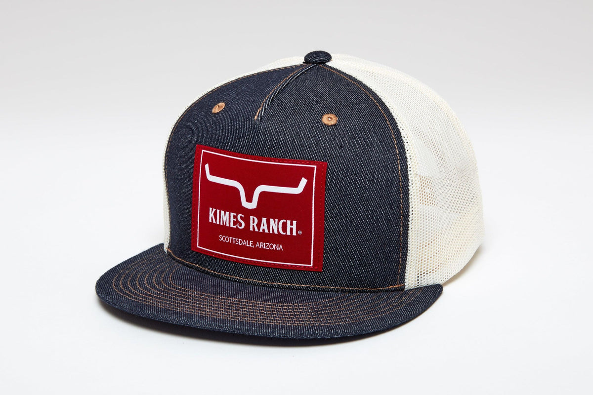 Kimes Ranch Blaster Trucker Hat, side view, with a red logo patch and cream mesh back