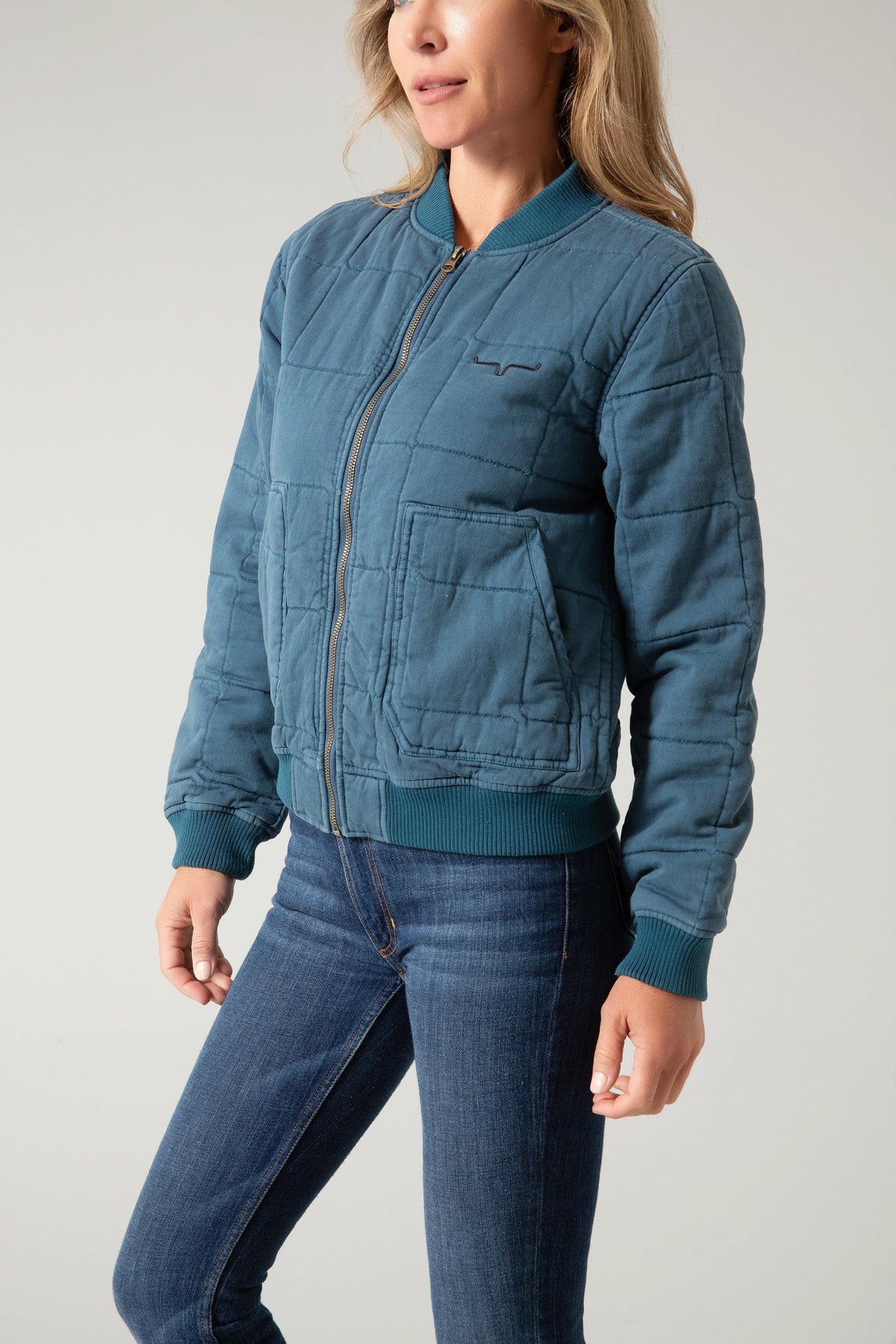 Kimes Ranch Bronc Bomber Jacket, side view, in teal with a quilted pattern, front zip, and ribbed trim