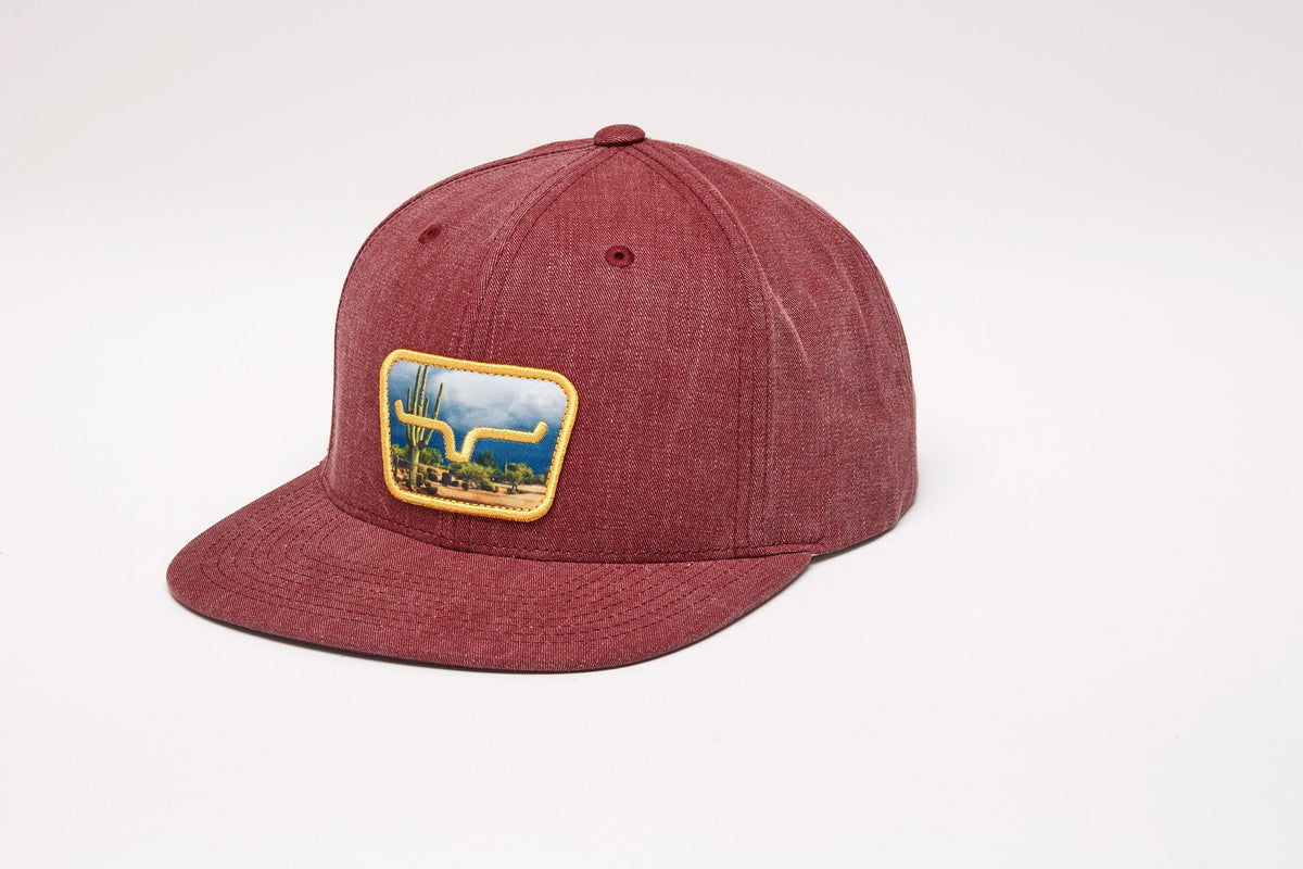 Kimes Ranch Buckley Hat in Port, side view, with a rectangular patch showing a cactus and the Kimes Ranch logo