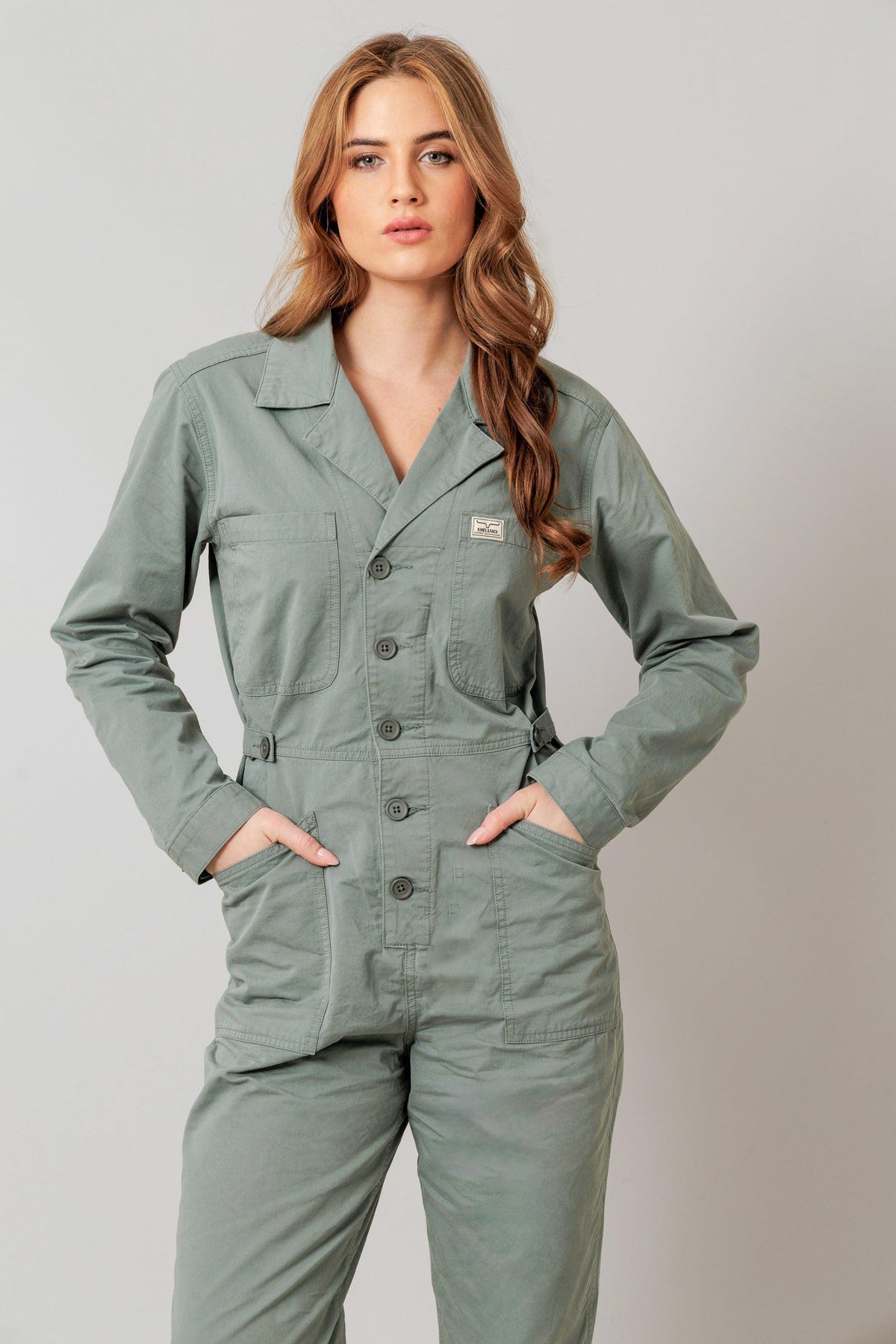 Kimes Ranch Chimayo Jumpsuit in Pine with a button front, collar, and patch pockets