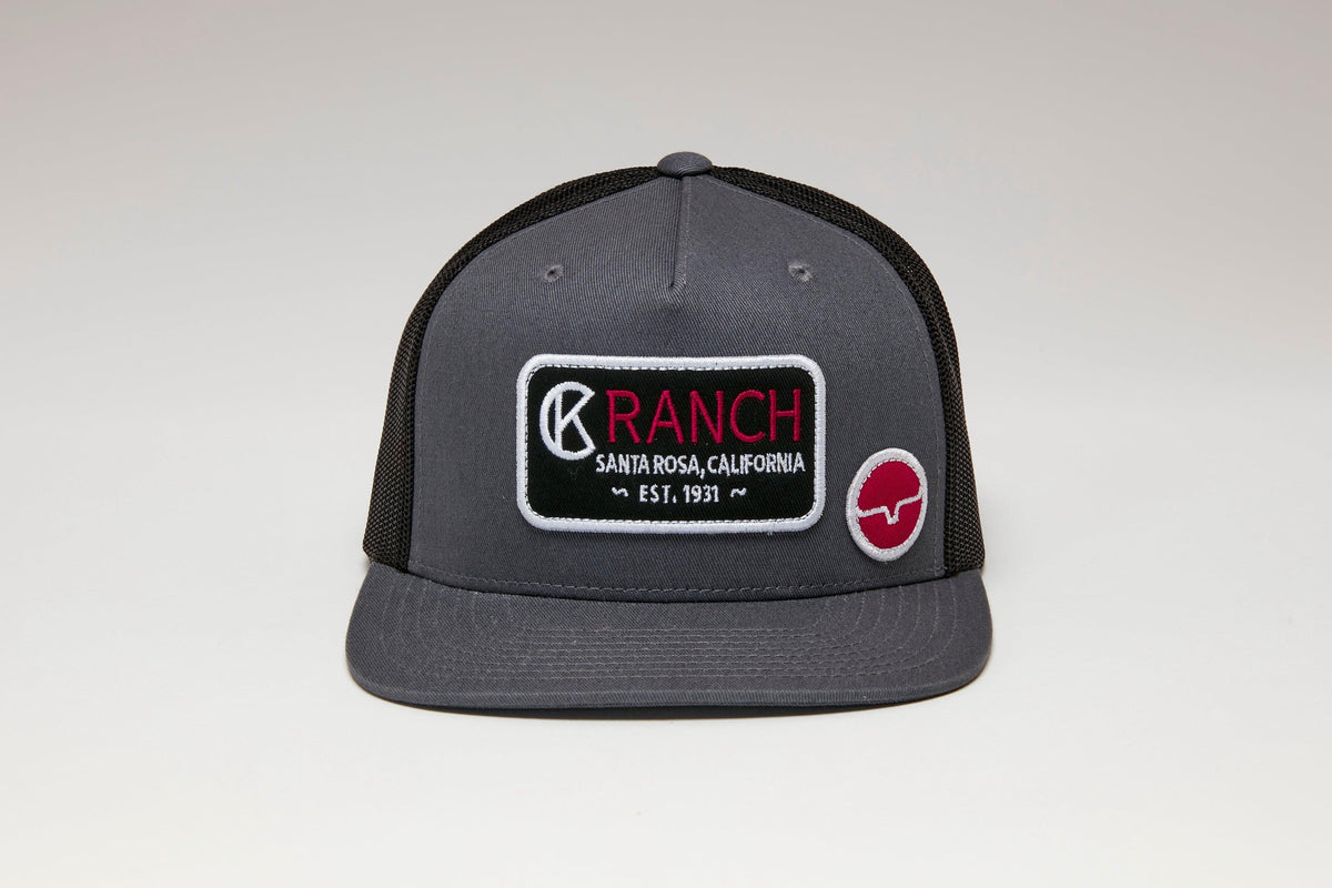 Kimes Ranch Ck31 Trucker Hat in Charcoal Black with a front embroidered logo patch and a side logo patch