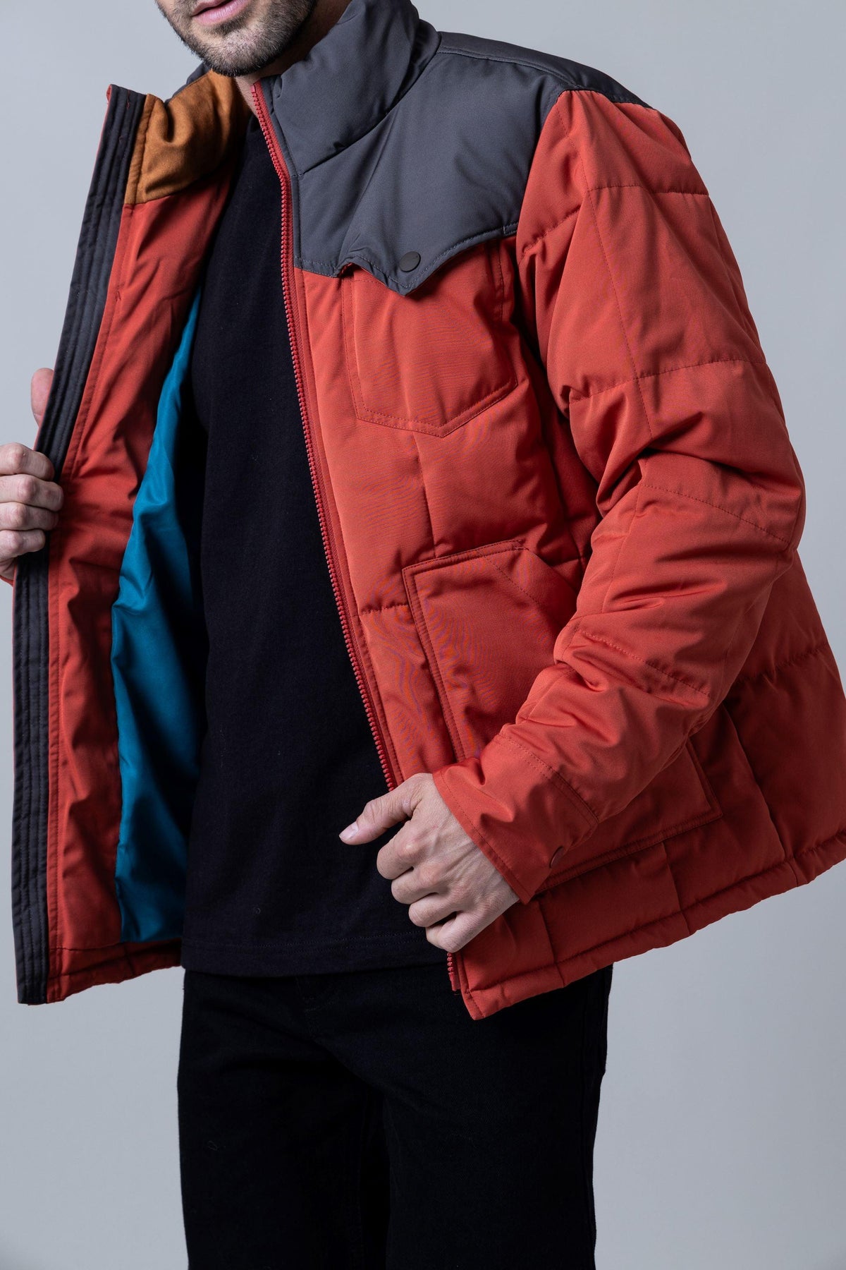 Kimes Ranch Colt Jacket in Rust Red with a grey yoke, front pockets, and a teal lining