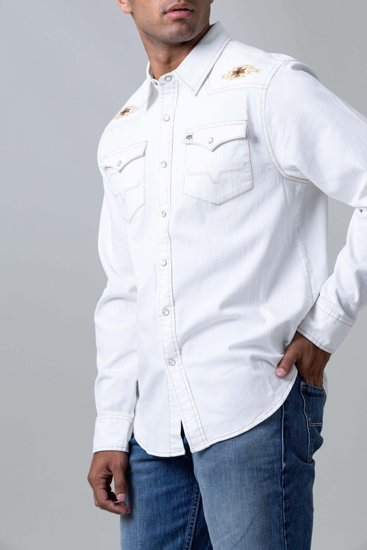 Kimes Ranch Durango Denim dress shirt in Natural, side view, with embroidered shoulder logos and contrast stitching