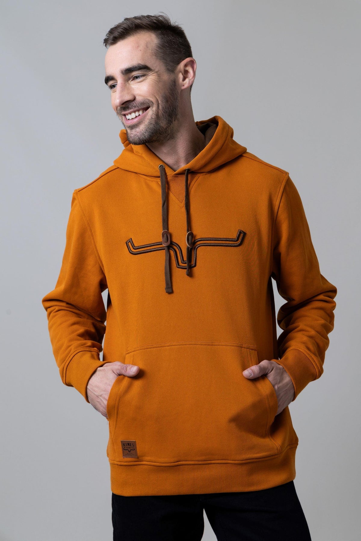 Kimes Ranch Fast Talker Hoodie in Burnt Orange with longhorn graphic and kangaroo pocket