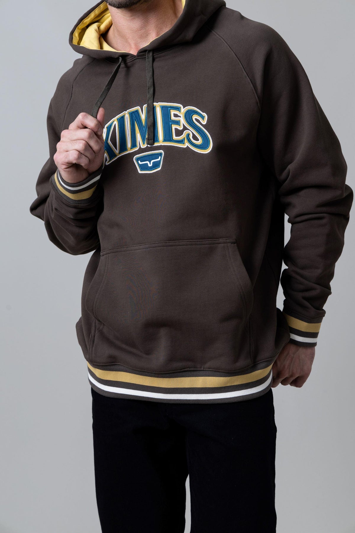 Kimes Ranch Kubo Hoodie in Dark Brown with a front Kimes Ranch logo and striped ribbed cuffs and hem