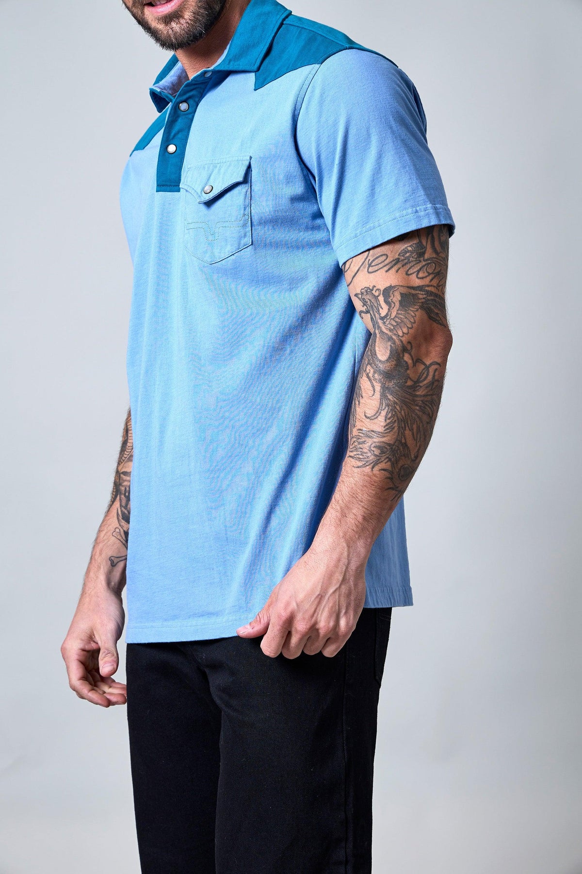 Kimes Ranch Gallup Polo in Light Blue, side view, with a darker blue collar and chest pocket