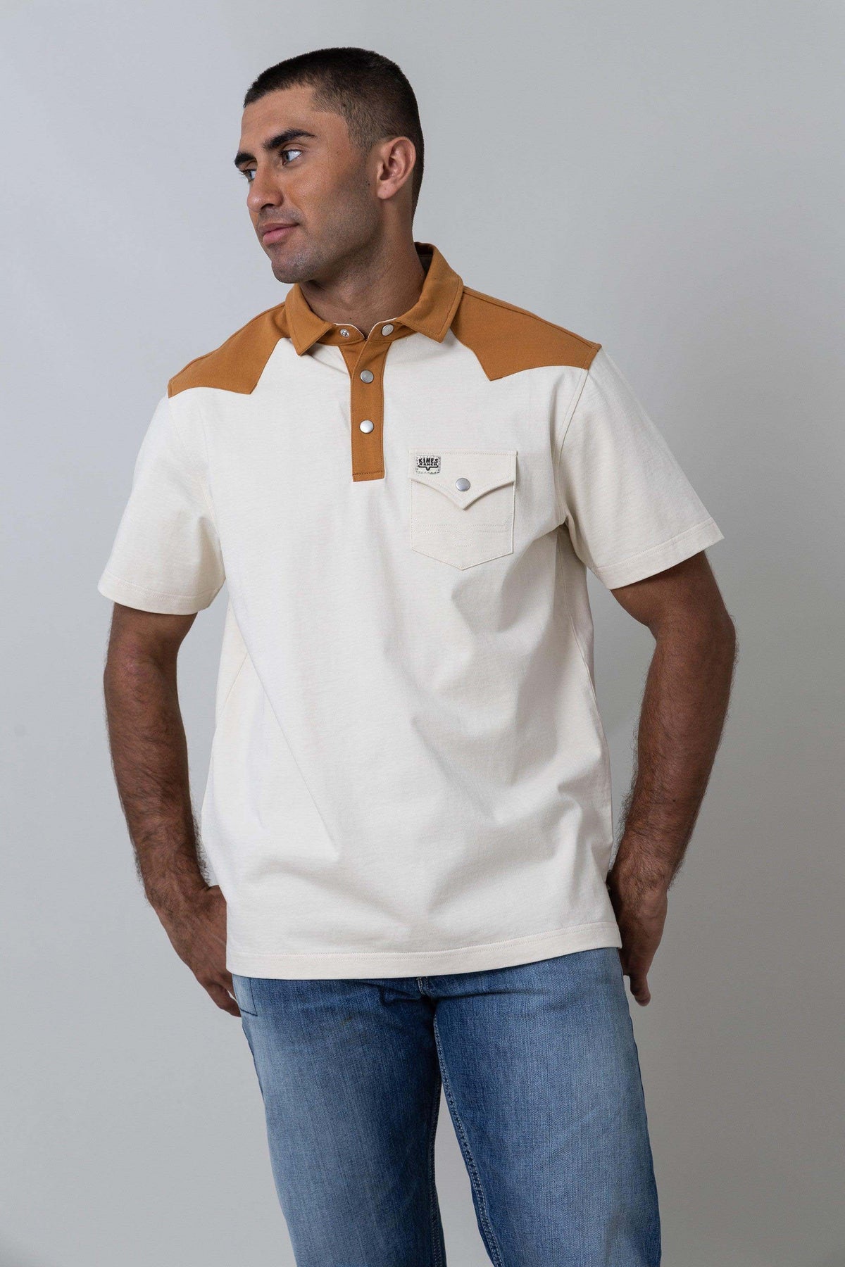 Kimes Ranch Gallup Polo in Natural with a tan collar and yoke, three-button placket, and chest pocket with logo
