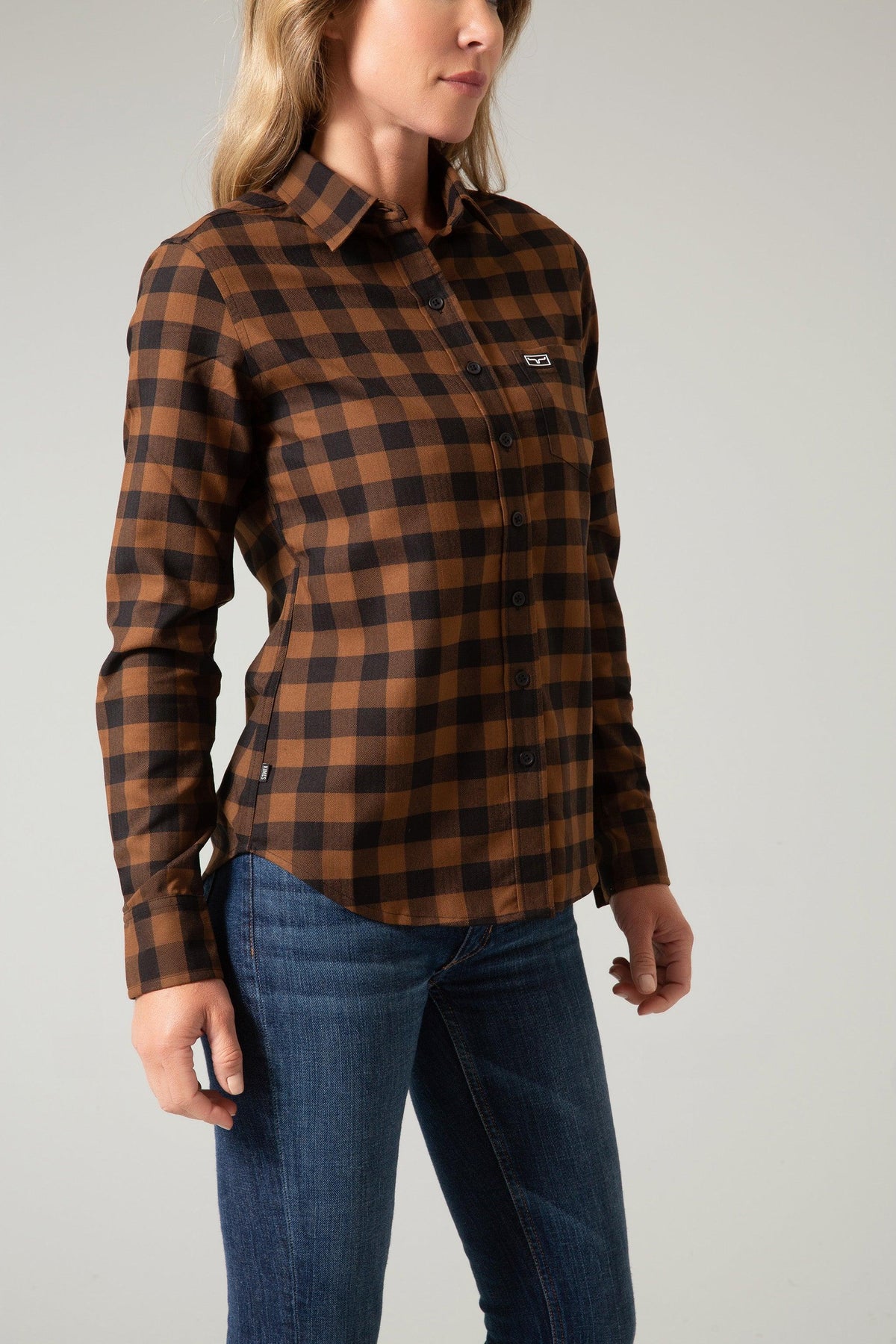 Kimes Ranch Ladies Garrison, side view, long sleeve button-up top in brown and black buffalo plaid with a chest pocket
