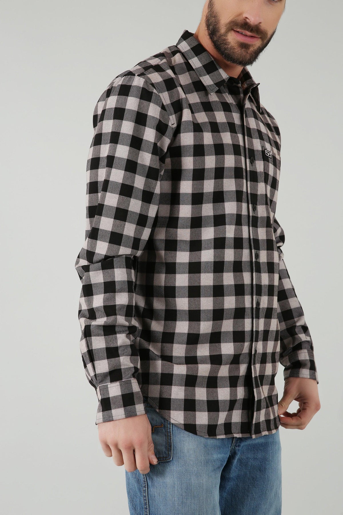 Kimes Ranch Garrison Dress Shirt in Grey Heather, side view, with a black and grey check pattern and a chest logo