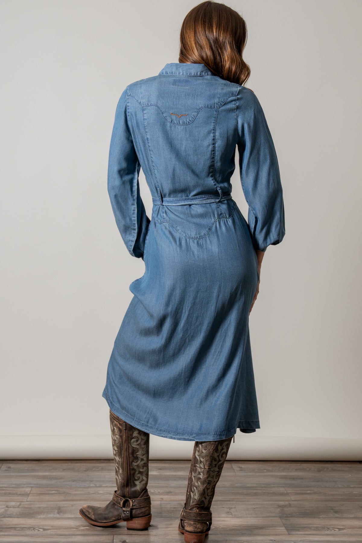 Kimes Ranch Channy skirt, back view showing long blue denim silhouette with belt and yoke detail