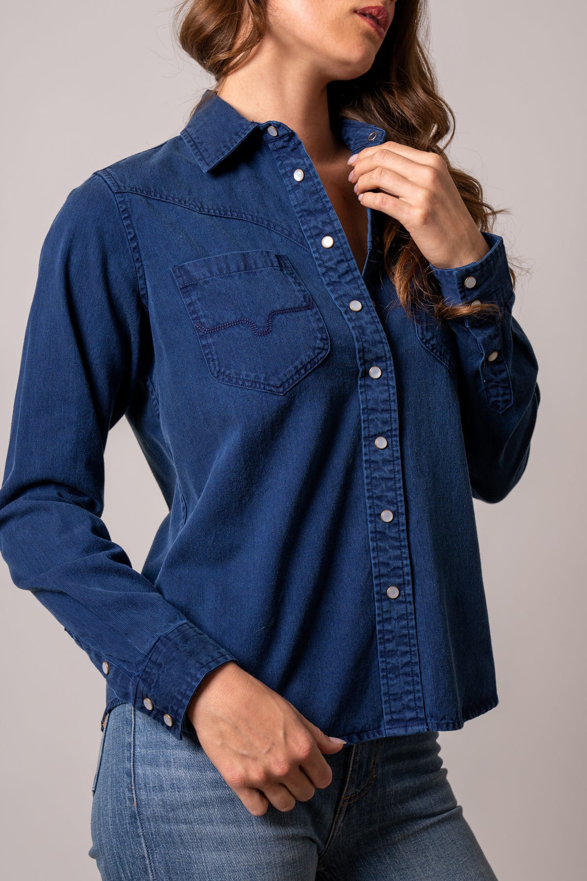 Kimes Ranch Della top in Dark Indigo, side view of long-sleeve pearl snap western shirt with yoke and chest pocket