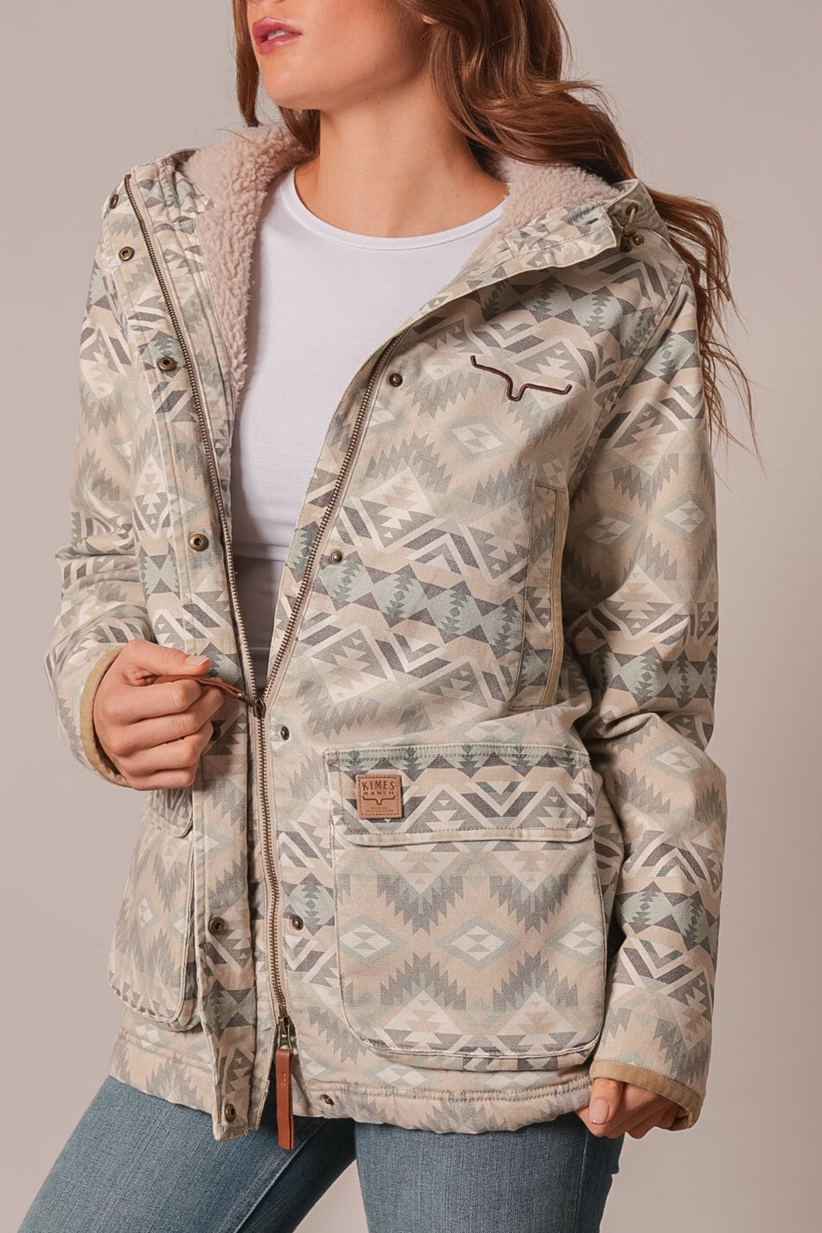 Kimes Ranch Emery jacket in Sand, aztec print with sherpa-lined hood, front flap pocket bearing logo