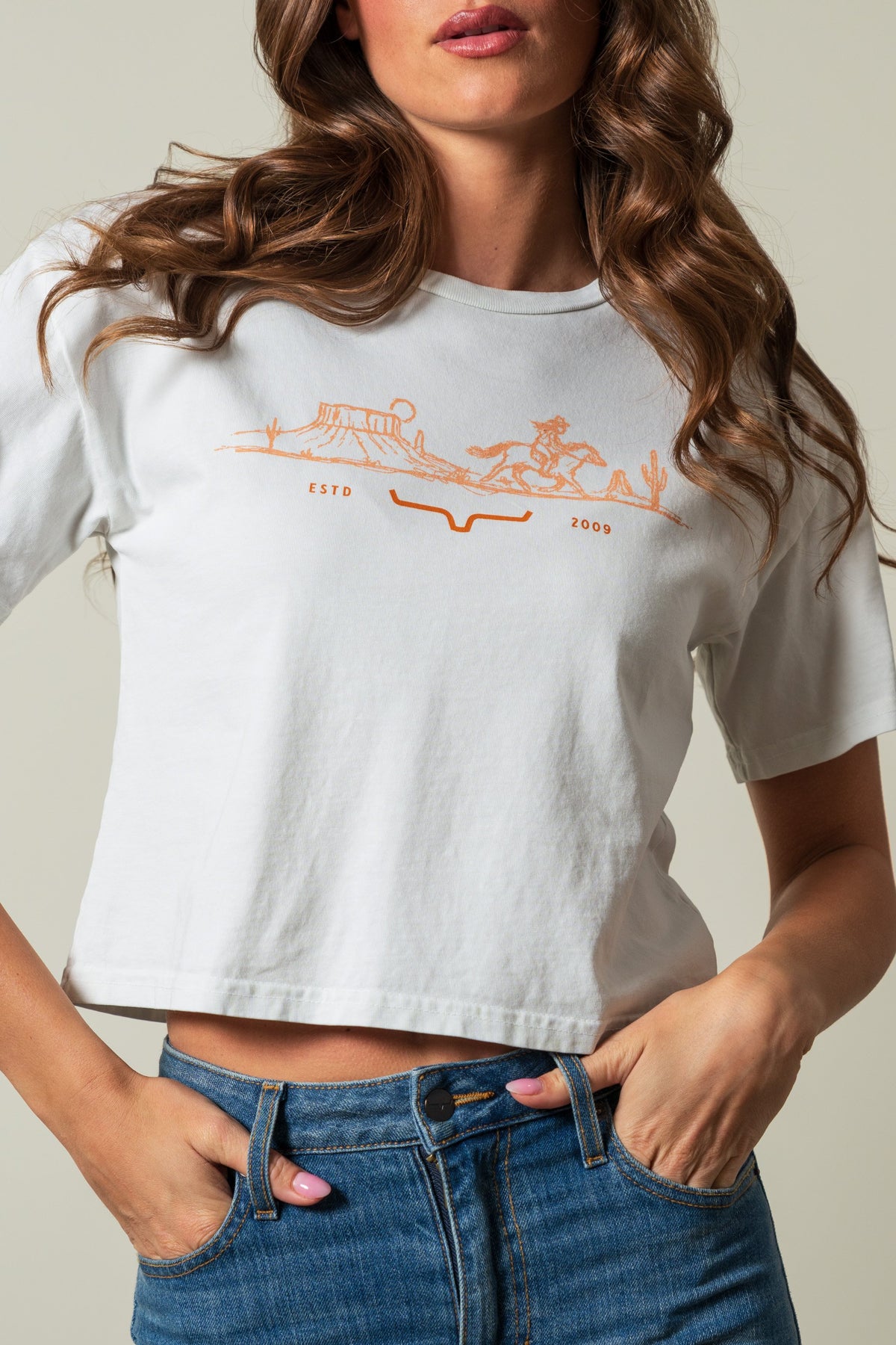 Kimes Ranch Go West short sleeve crop shirt in natural with orange western landscape graphic and ESTD 2009 text