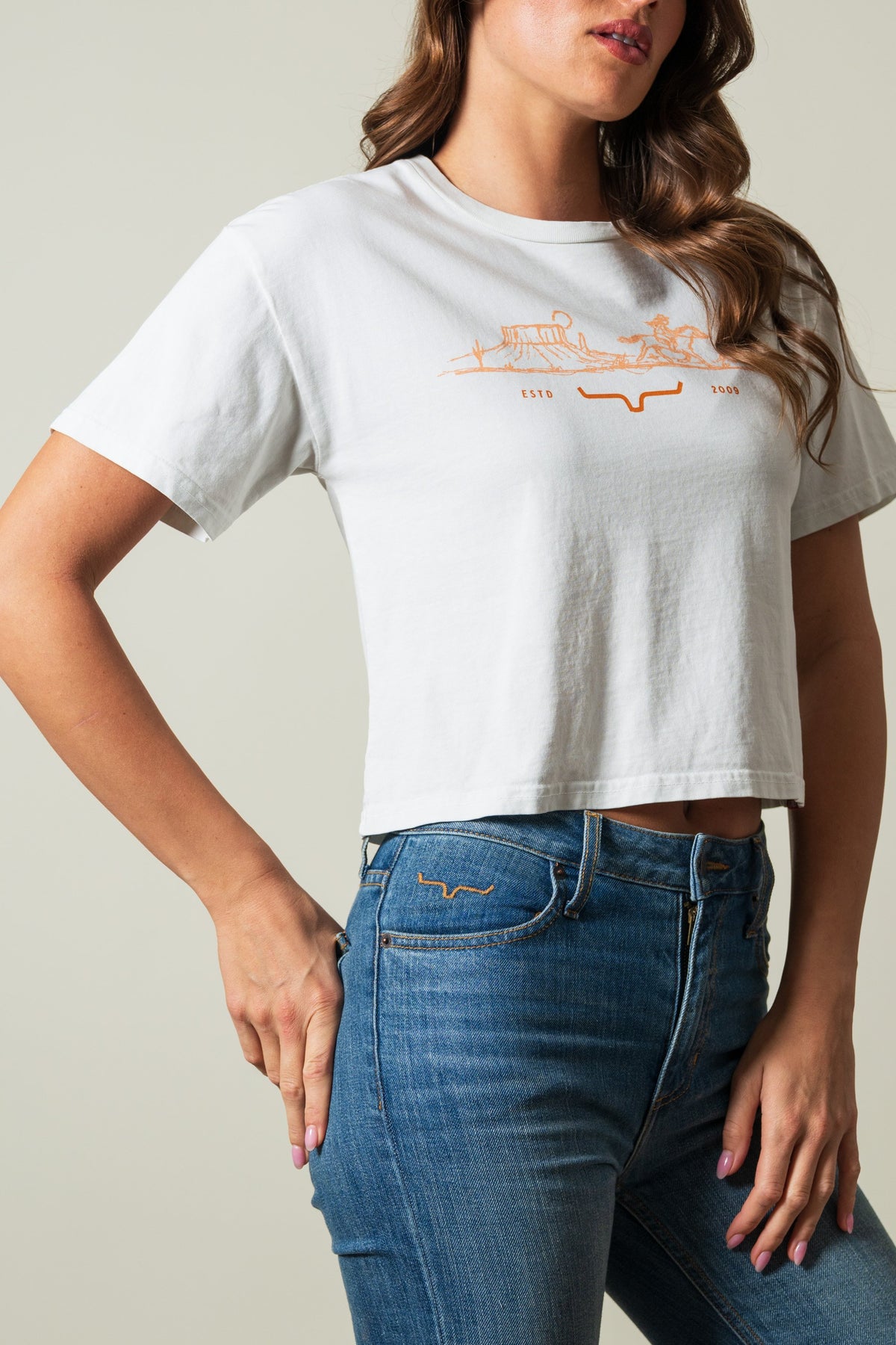 Kimes Ranch Go West short sleeve natural t-shirt with orange landscape graphic reading ESTO 2009 and steer logo