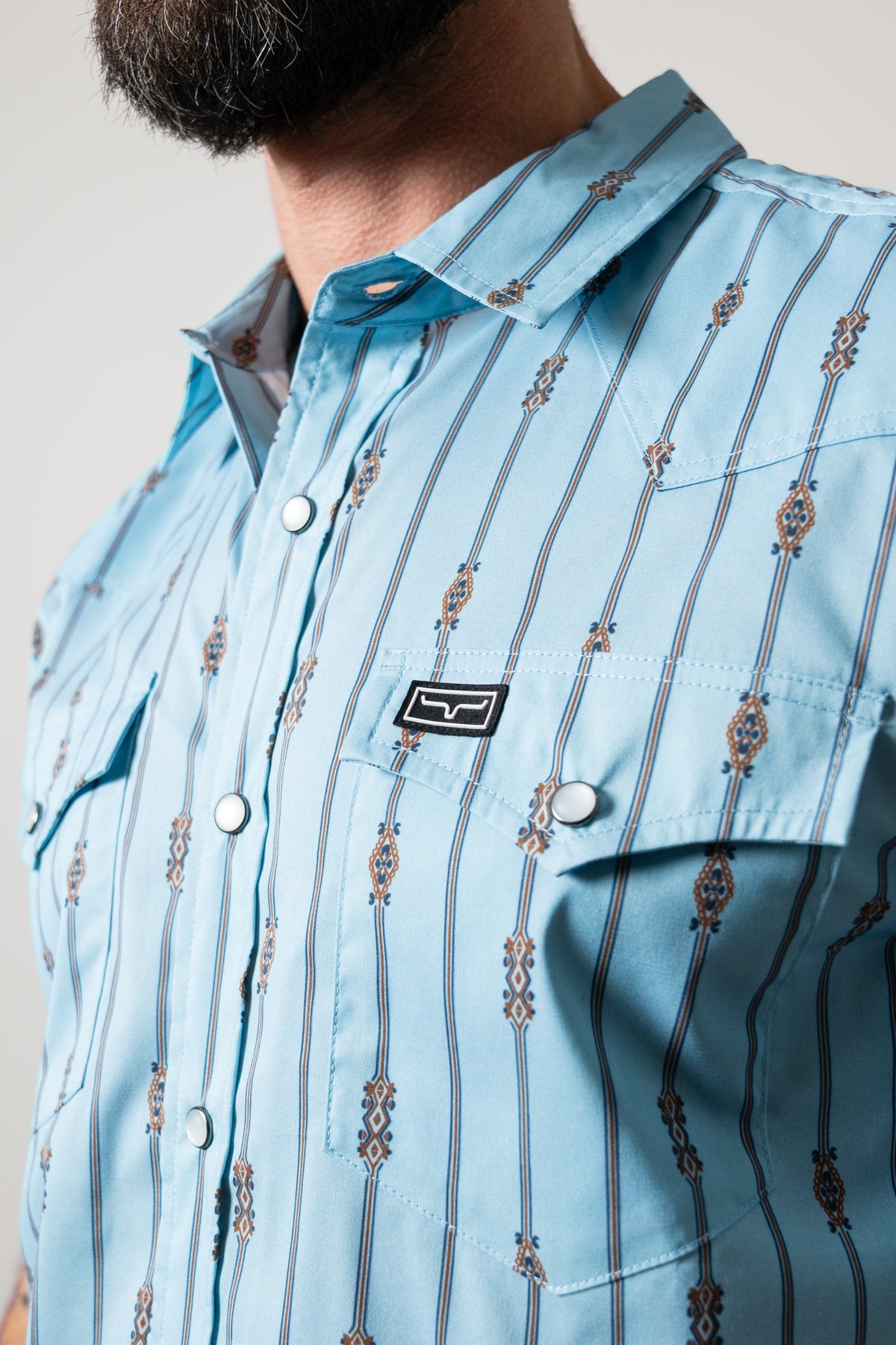 Kimes Ranch Gunner dress shirt, Light Blue with tribal motifs, Kimes Ranch logo patch on pocket, collar, and snap closure