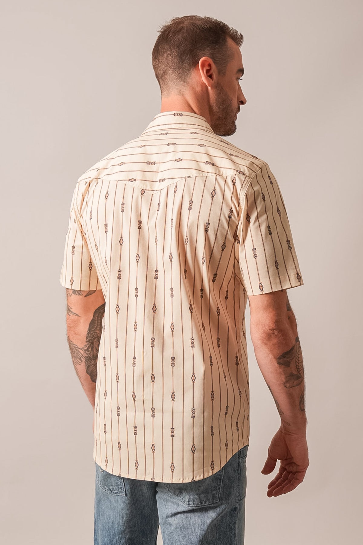 Kimes Ranch Gunner dress shirt in natural with short sleeves, back yoke, and a repeating geometric stripe pattern on cream