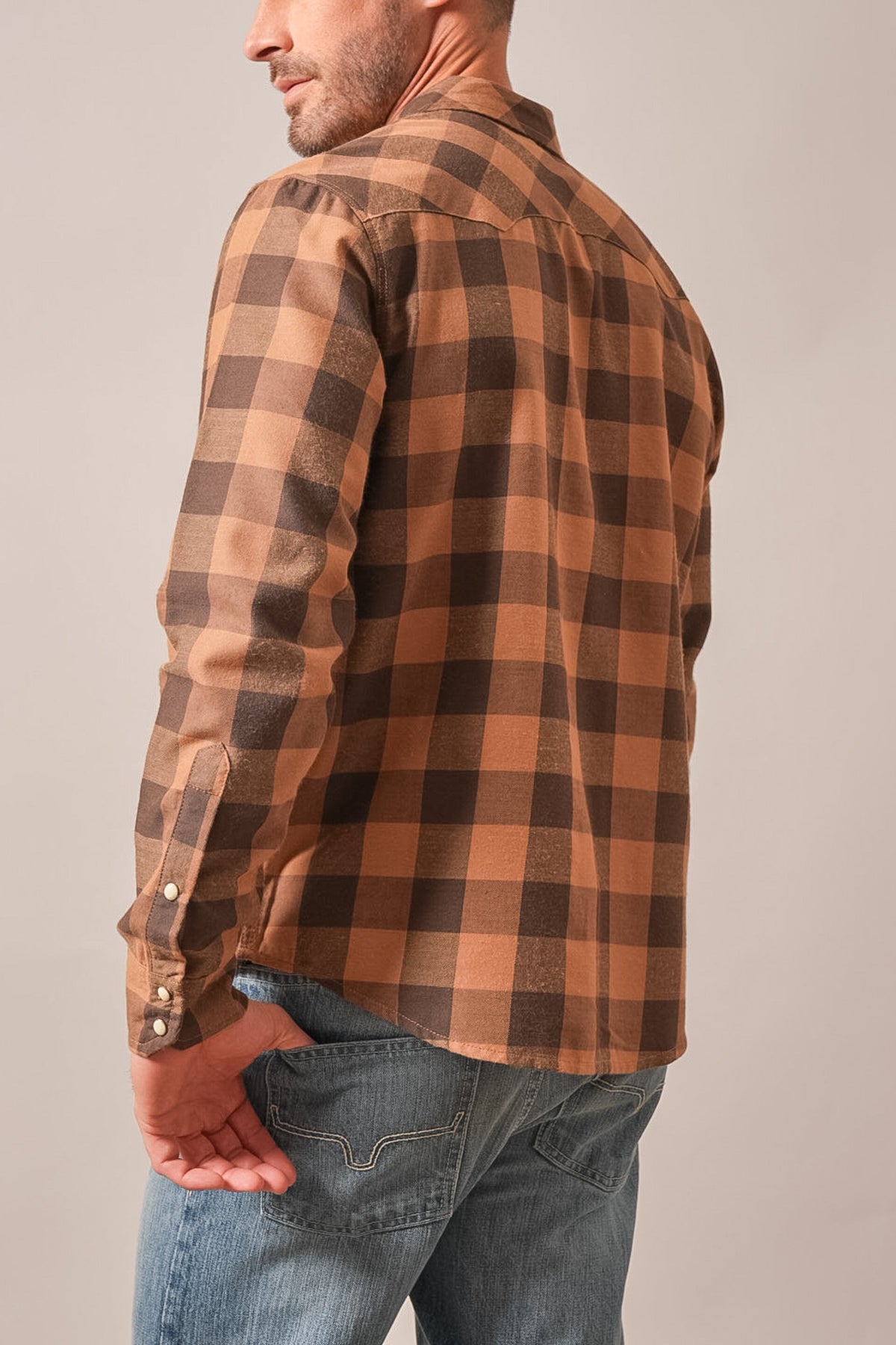Kimes Ranch Jonez dress shirt in Work Wear Brown, showing back view of long sleeves, buttoned cuffs, and plaid pattern