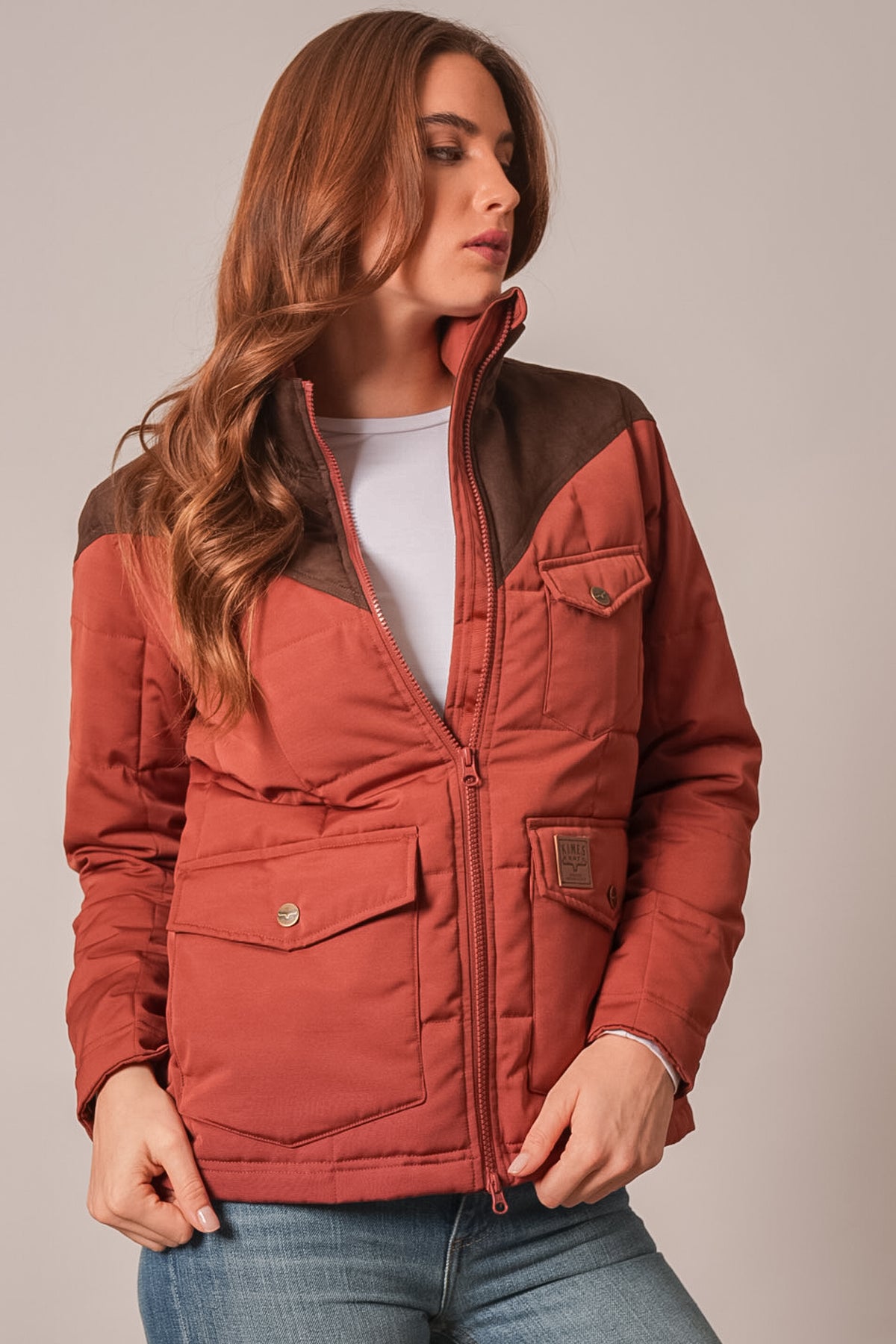 Kimes Ranch Lenora jacket in burnt red with long sleeves and front pockets, featuring the Kimes Ranch logo on the left chest