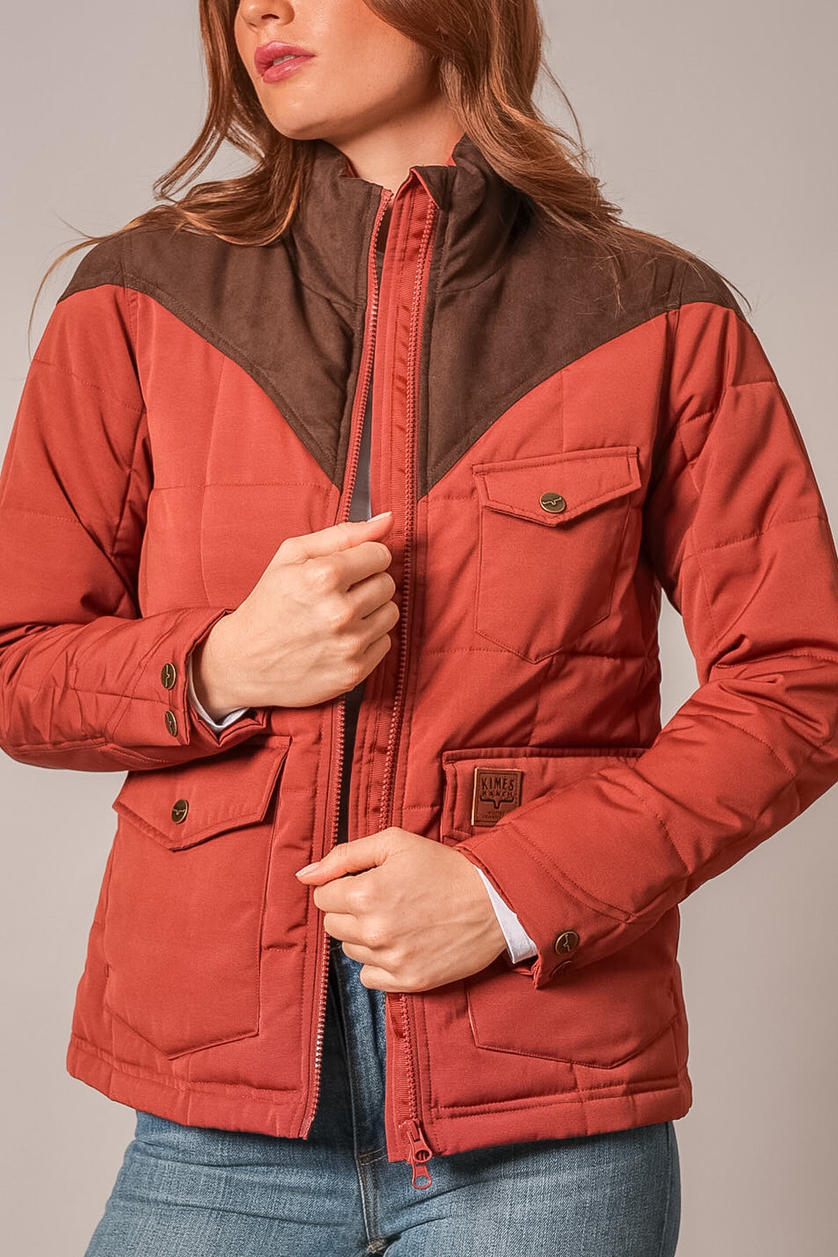 Kimes Ranch Lenora Jacket in Burnt Red with quilted detailing, contrast brown suede yoke, and Kimes Ranch logo patch