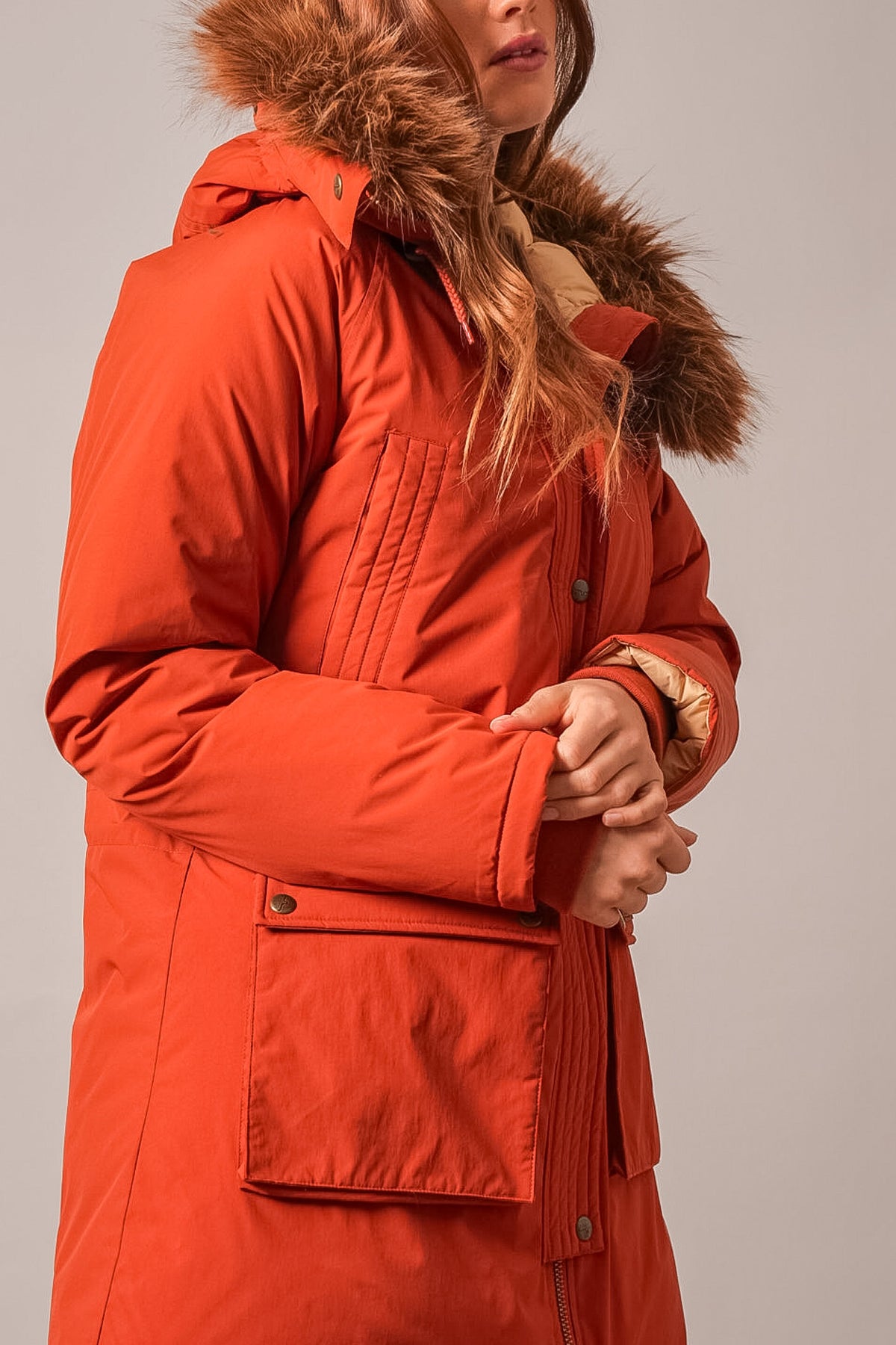 Kimes Ranch Montana jacket in Burnt Red with fur-trim hood, front patch pocket, and button closure
