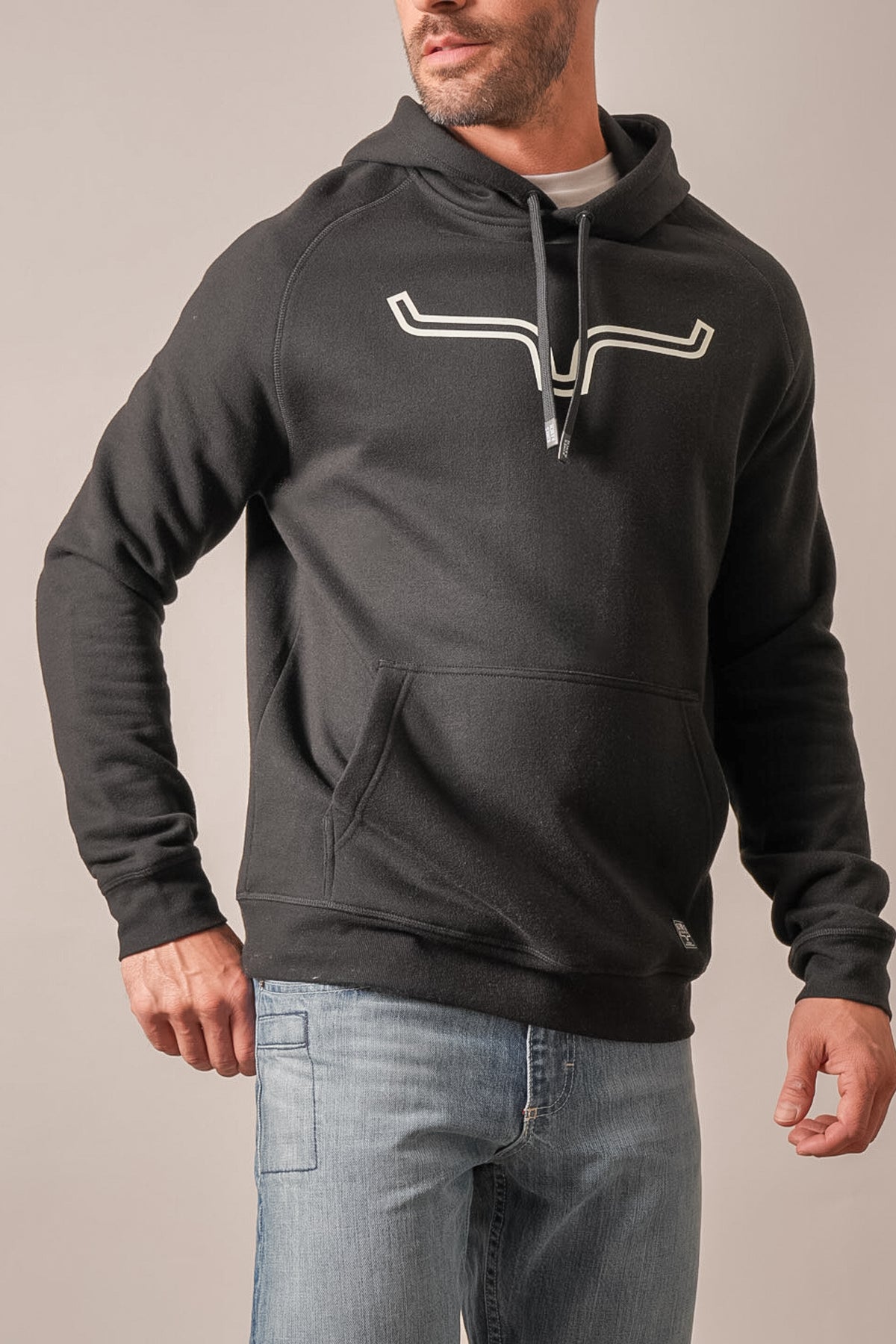 Kimes Ranch Outlier black hoodie with white Kimes Ranch logo on front, featuring a hood, long sleeves, and kangaroo pocket