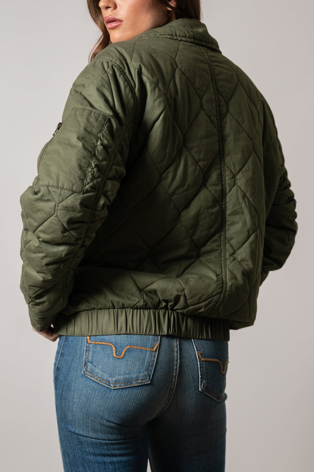 Kimes Ranch Phoeby jacket, back view in moss, featuring quilted diamond pattern, long sleeves, and elastic hem