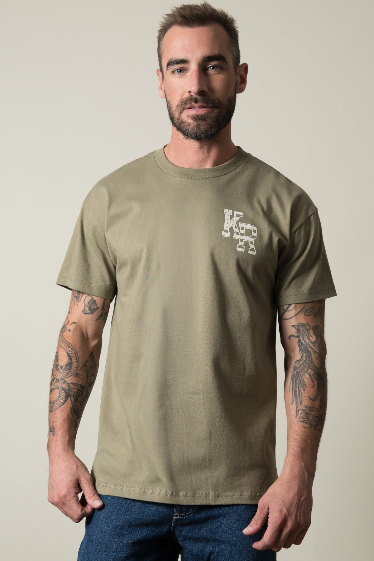 Kimes Ranch Red Glare shirt in Light olive, featuring a short-sleeve crewneck with a small Kimes Ranch logo on the front