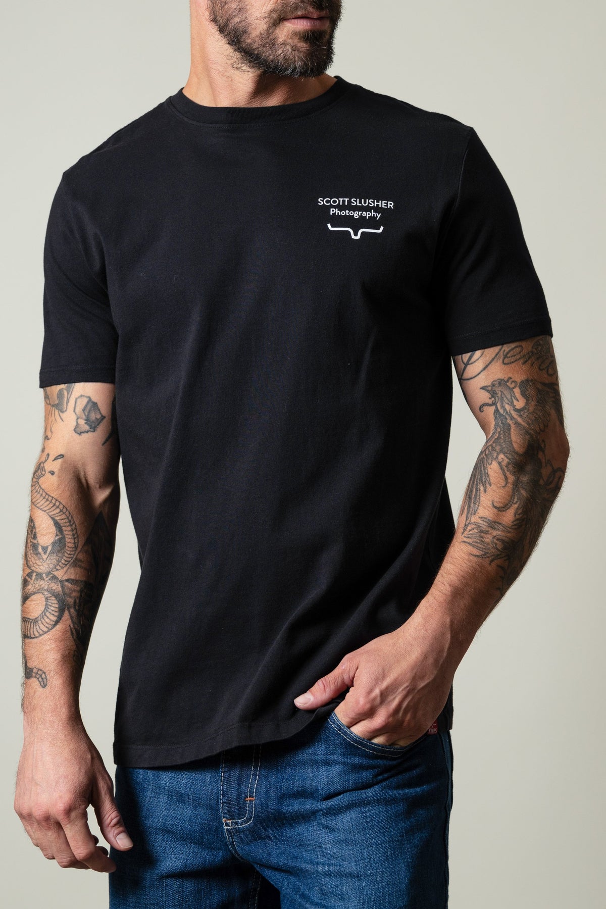Kimes Ranch SS Bronc Ride Black t-shirt with white SCOTT SLUSHER Photography text and logo