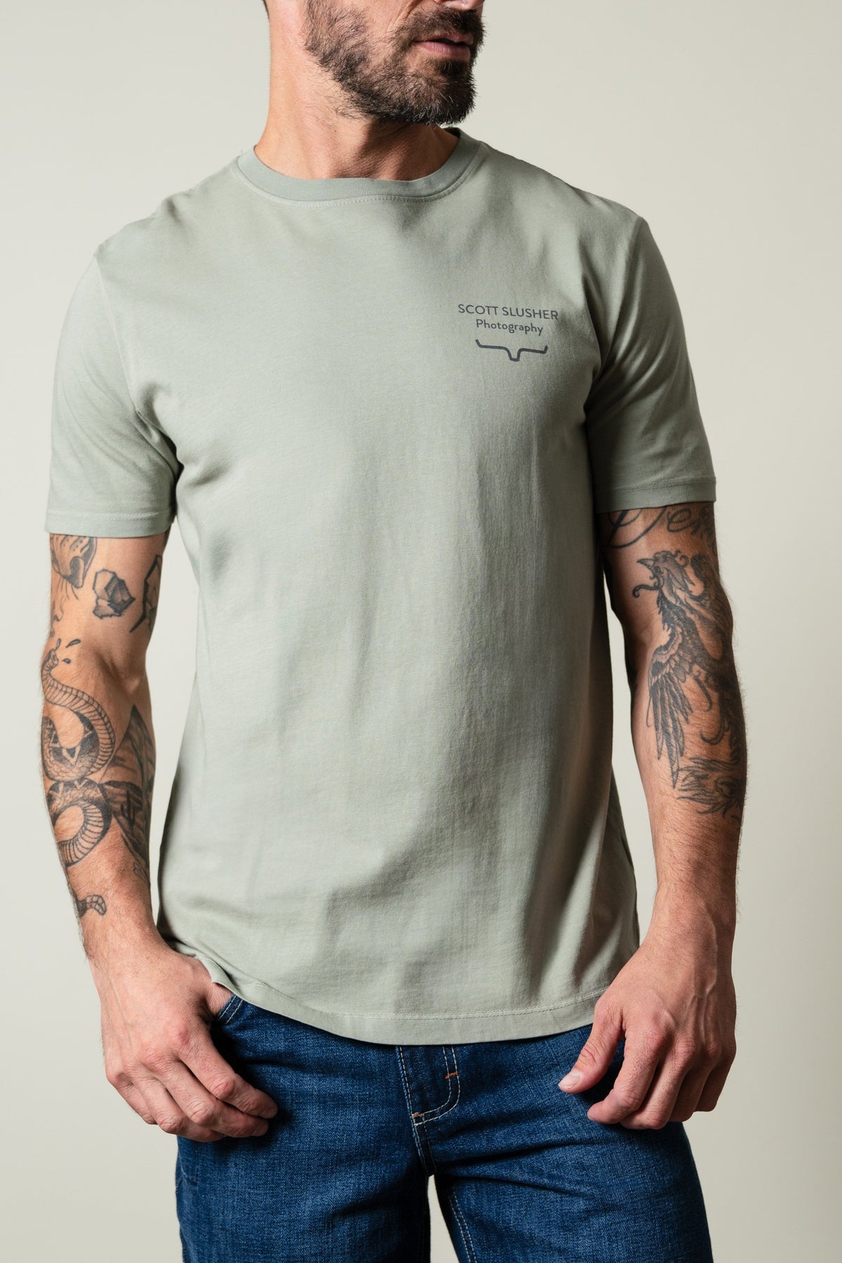 Kimes Ranch SS Bronc Ride Sage short sleeve t-shirt with SCOTT SLUSHER Photography text and logo chest graphic