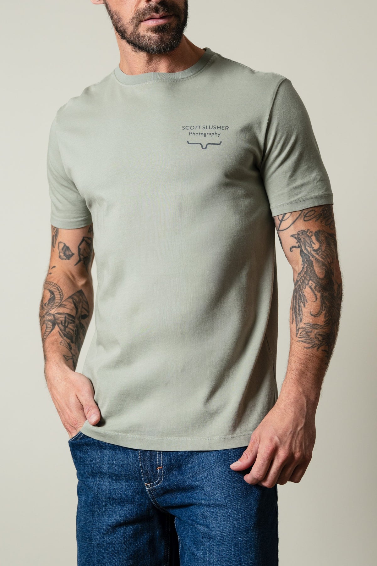 Kimes Ranch SS Bronc Ride Sage t-shirt with crew neck, short sleeves, and "SCOTT SLUSHER Photography" chest graphic